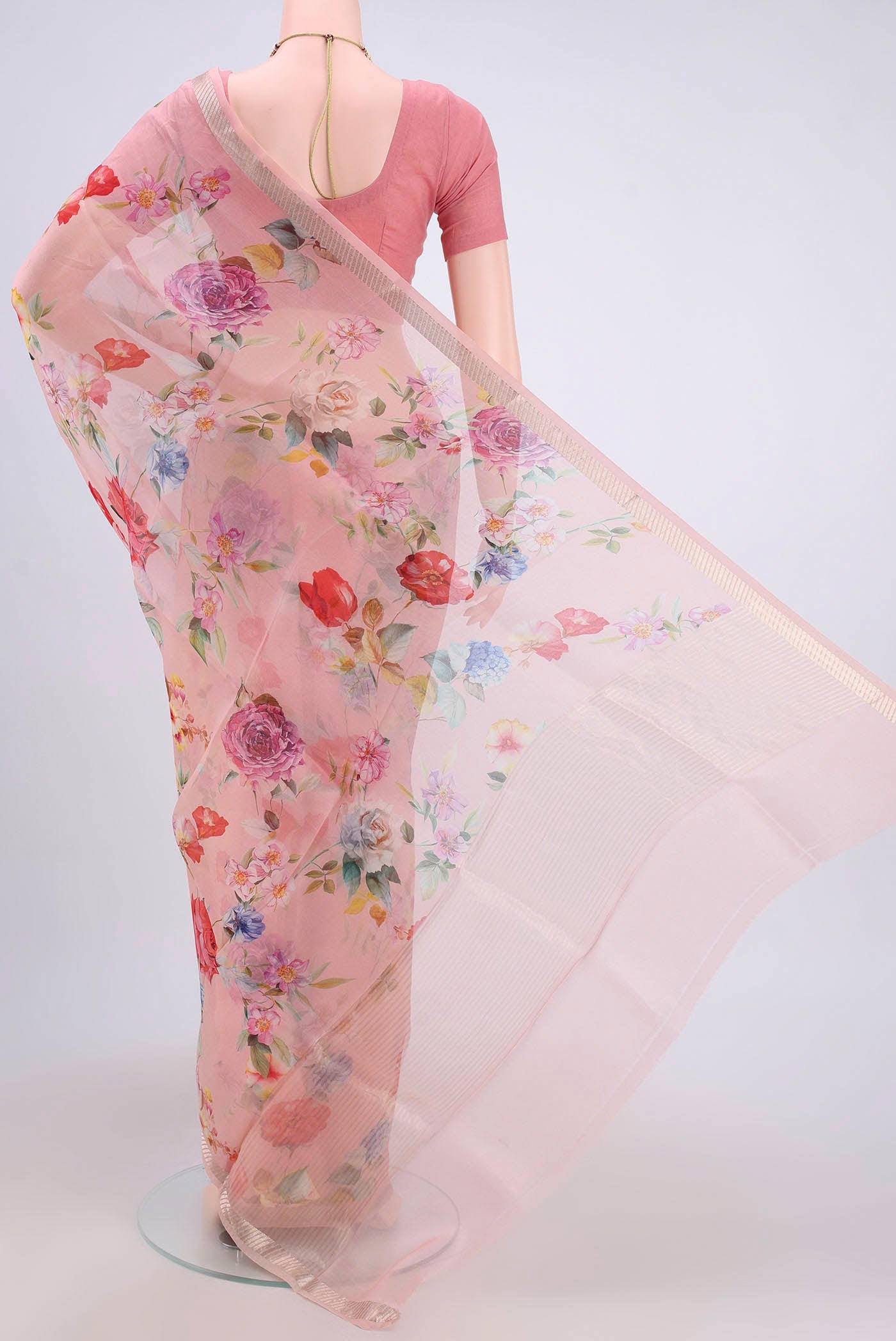 Flat view of Rani Pink Organza Silk Saree with Floral Print on the body and Zari Border. 