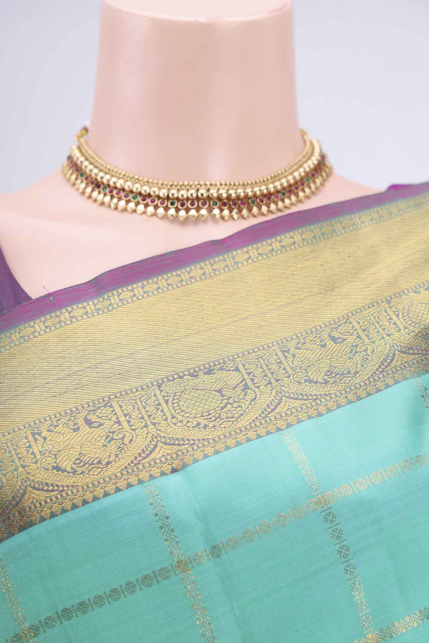 Border image of Turquoise Kanjivaram Saree with Zari Butta on the body and Zari Border. 