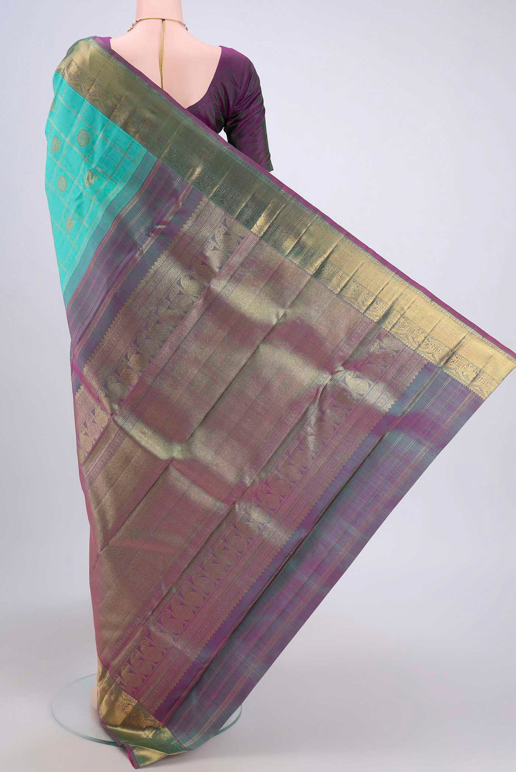 Flat view of Turquoise Kanjivaram Saree with Zari Butta on the body and Zari Border. 