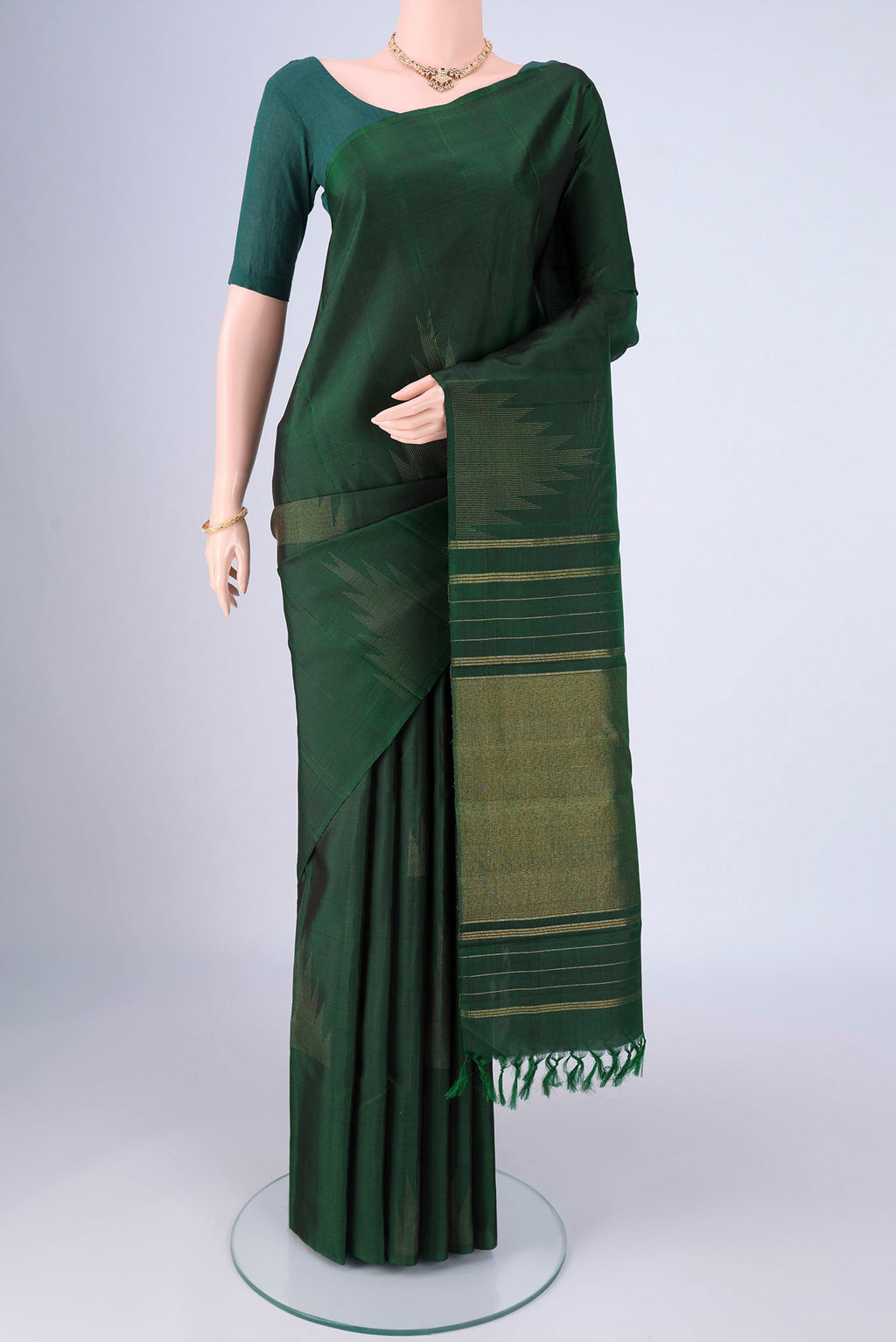 Bottle Green Kanchipuram Silk Saree with Plain Body and Temple Border.  displayed on a mannequin