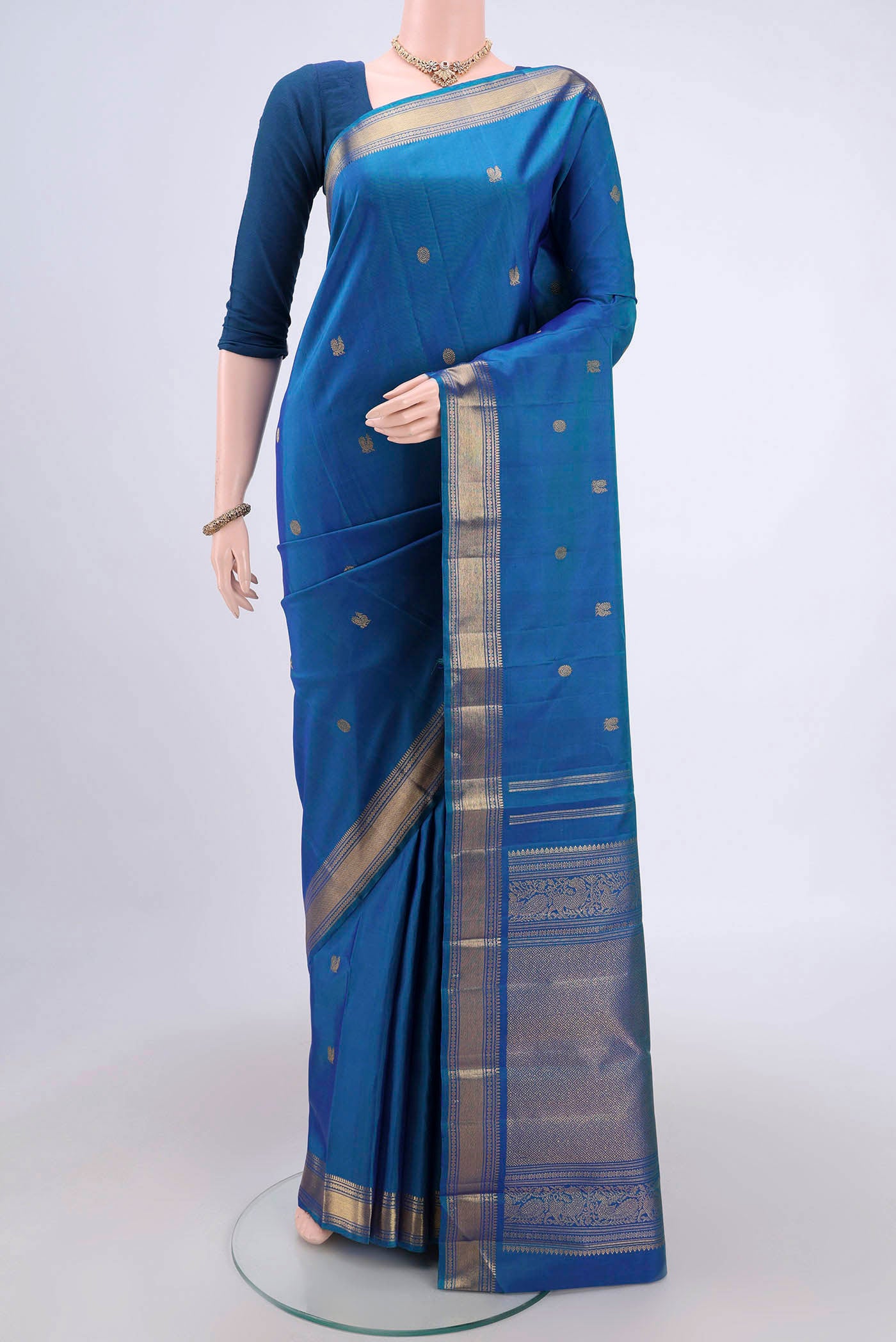 Blue Dual Tone Kanjivaram Silk Saree with Zari Butta on the body and Zari Border.  displayed on a mannequin