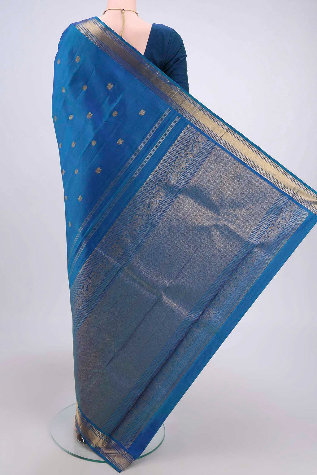 Flat view of Blue Dual Tone Kanjivaram Silk Saree with Zari Butta on the body and Zari Border. 