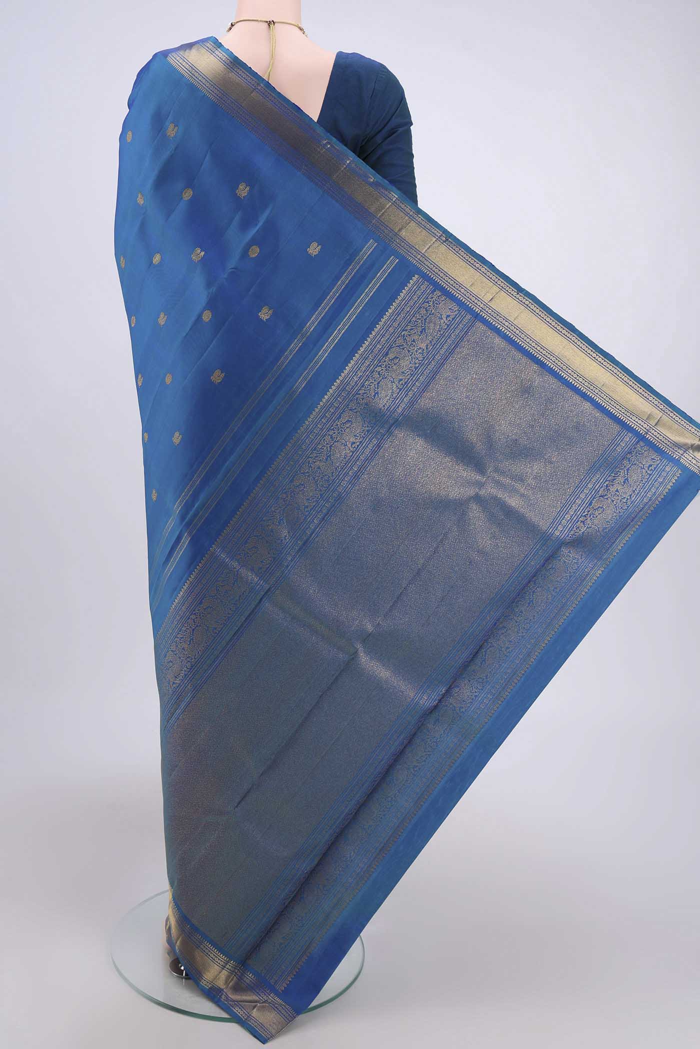 Flat view of Blue Dual Tone Kanjivaram Silk Saree with Zari Butta on the body and Zari Border. 