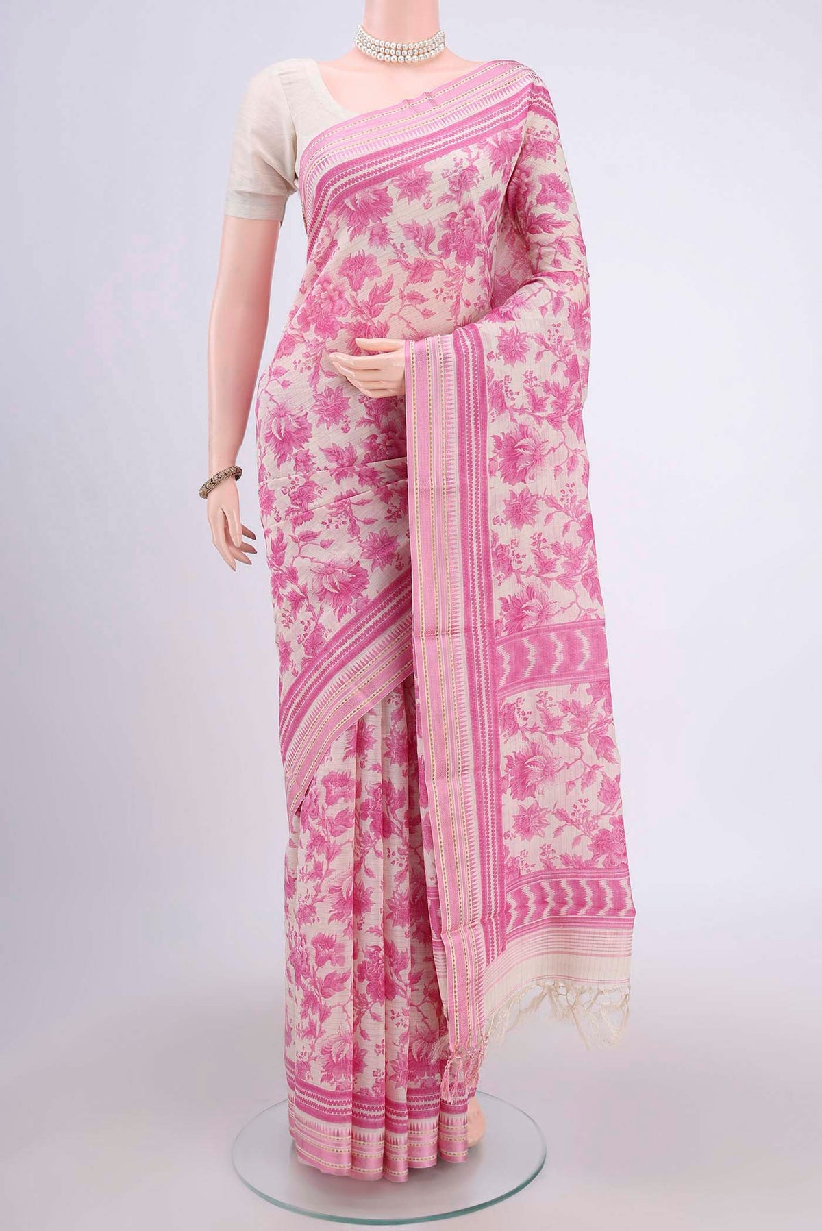Cream Tussar Saree with Floral Print on the body and Thread Border.  displayed on a mannequin