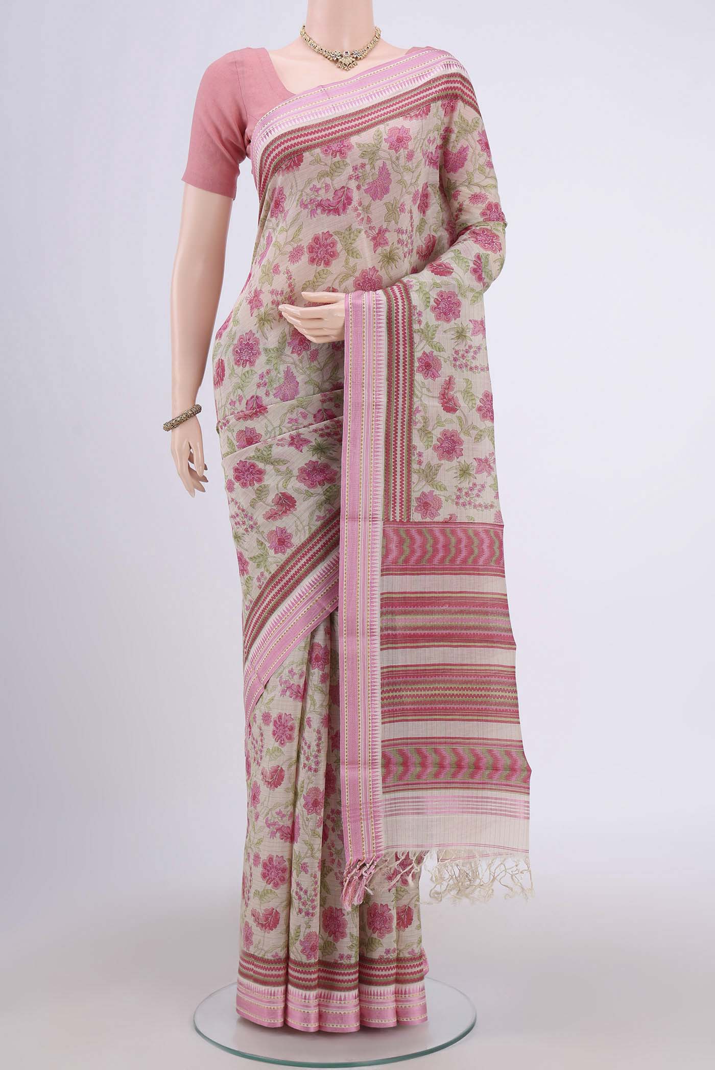 Beige Tussar Saree with Floral Print on the body and Thread Border.  displayed on a mannequin