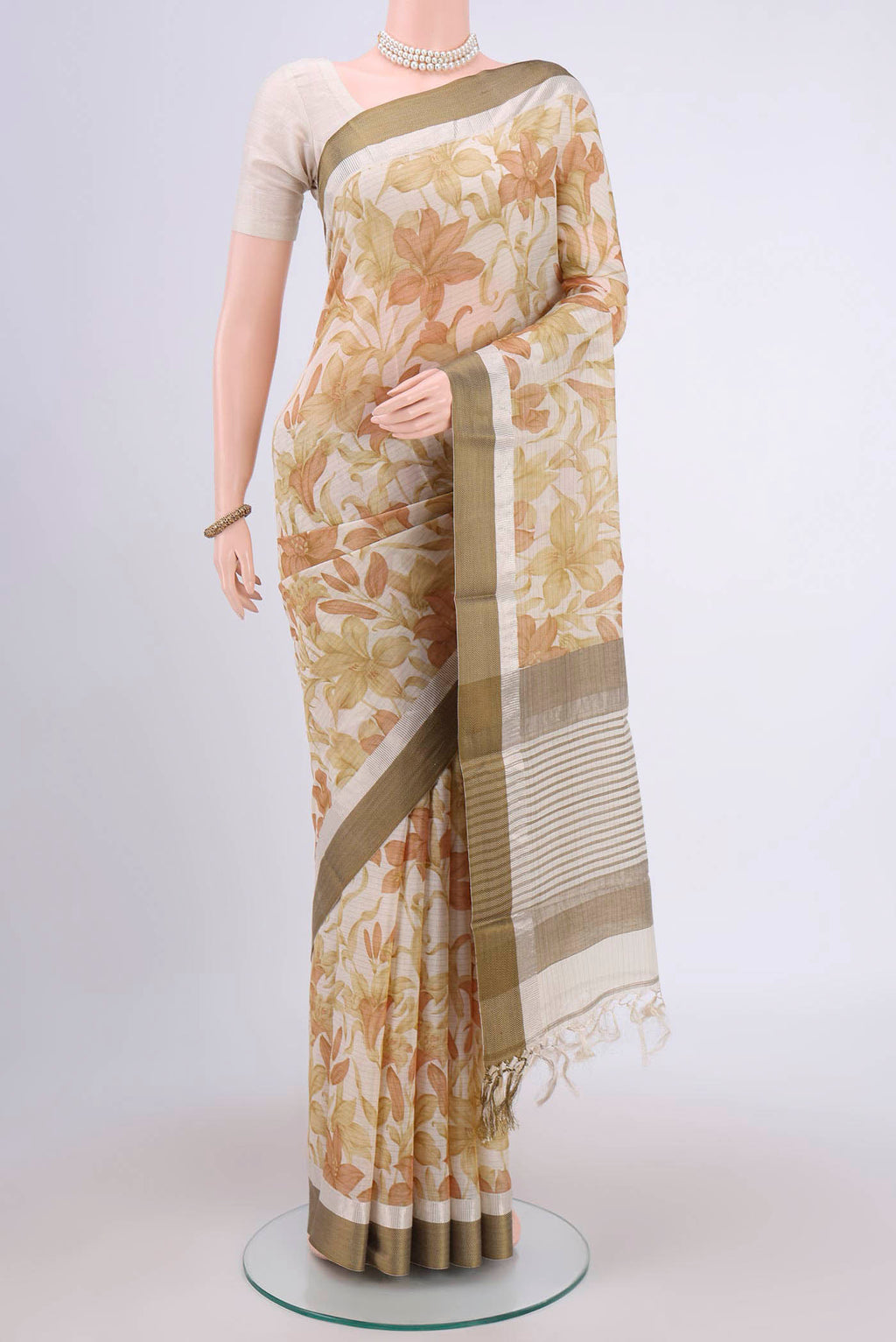 Off White Tussar Saree with Floral Print on the body and Plain Border.  displayed on a mannequin