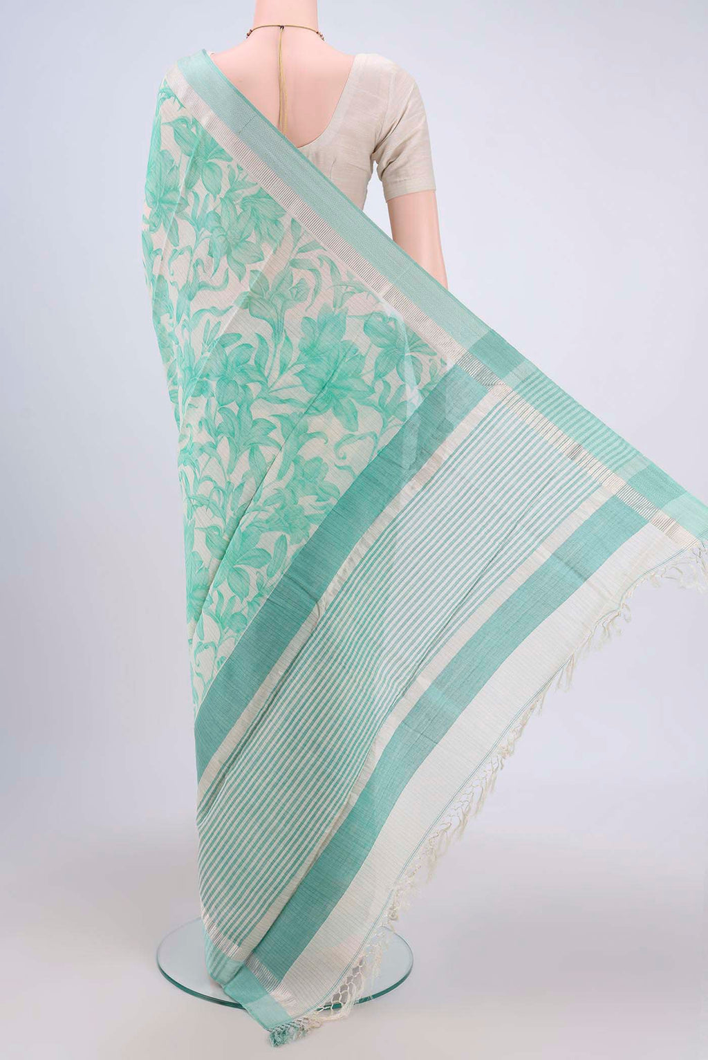 Flat view of Off White Tussar Saree with Floral Print on the body and Plain Border. 