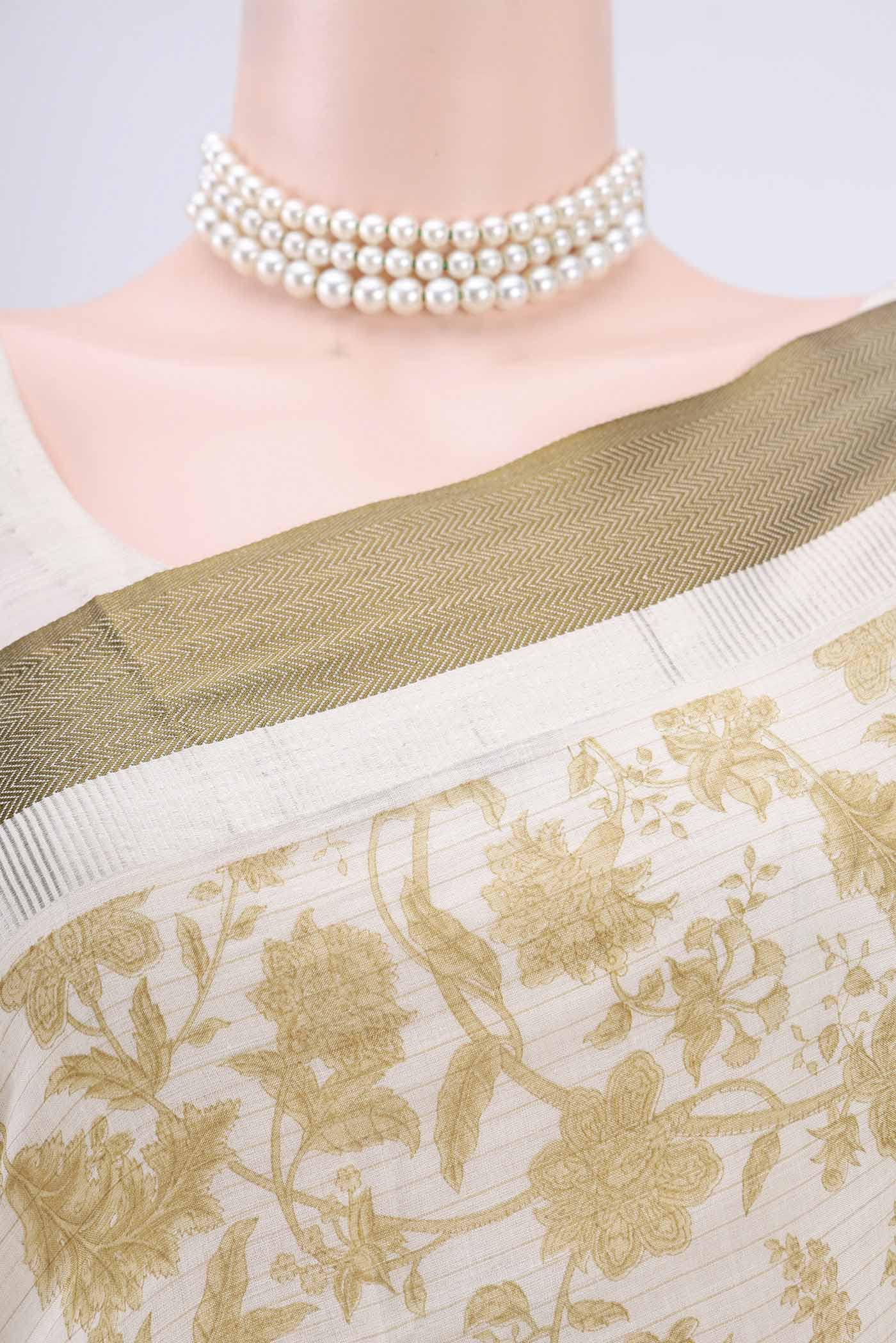 Border image of Cream Tussar Saree with Floral Print on the body and Thread Border. 