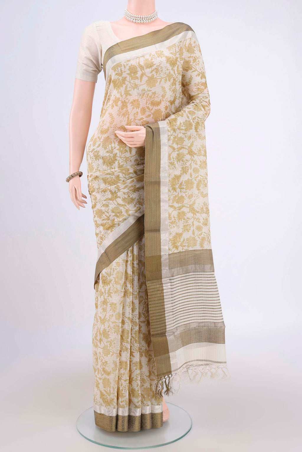 Cream Tussar Saree with Floral Print on the body and Thread Border.  displayed on a mannequin