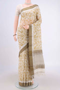 Cream Tussar Saree with Floral Print on the body and Thread Border.  displayed on a mannequin