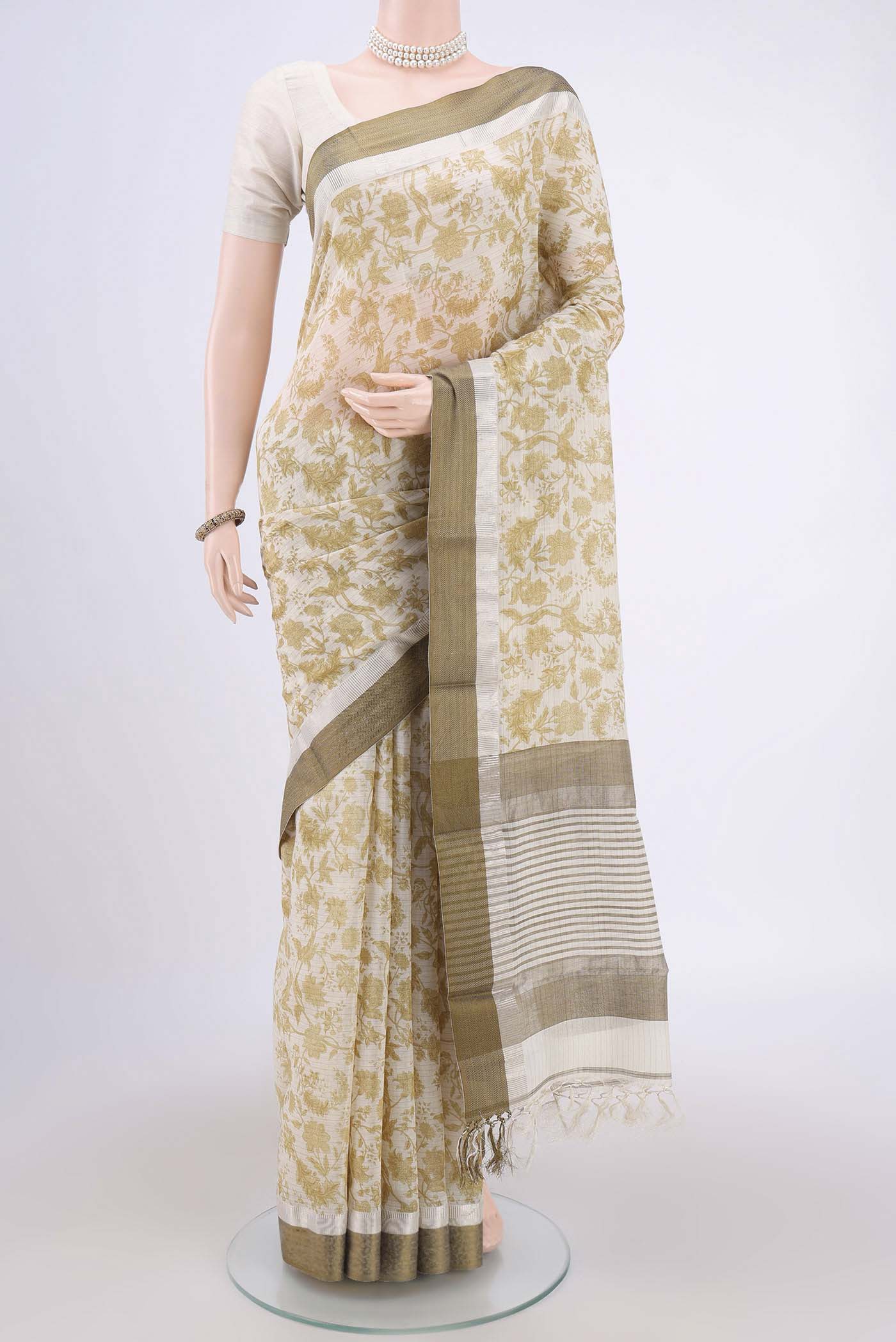 Cream Tussar Saree with Floral Print on the body and Thread Border.  displayed on a mannequin