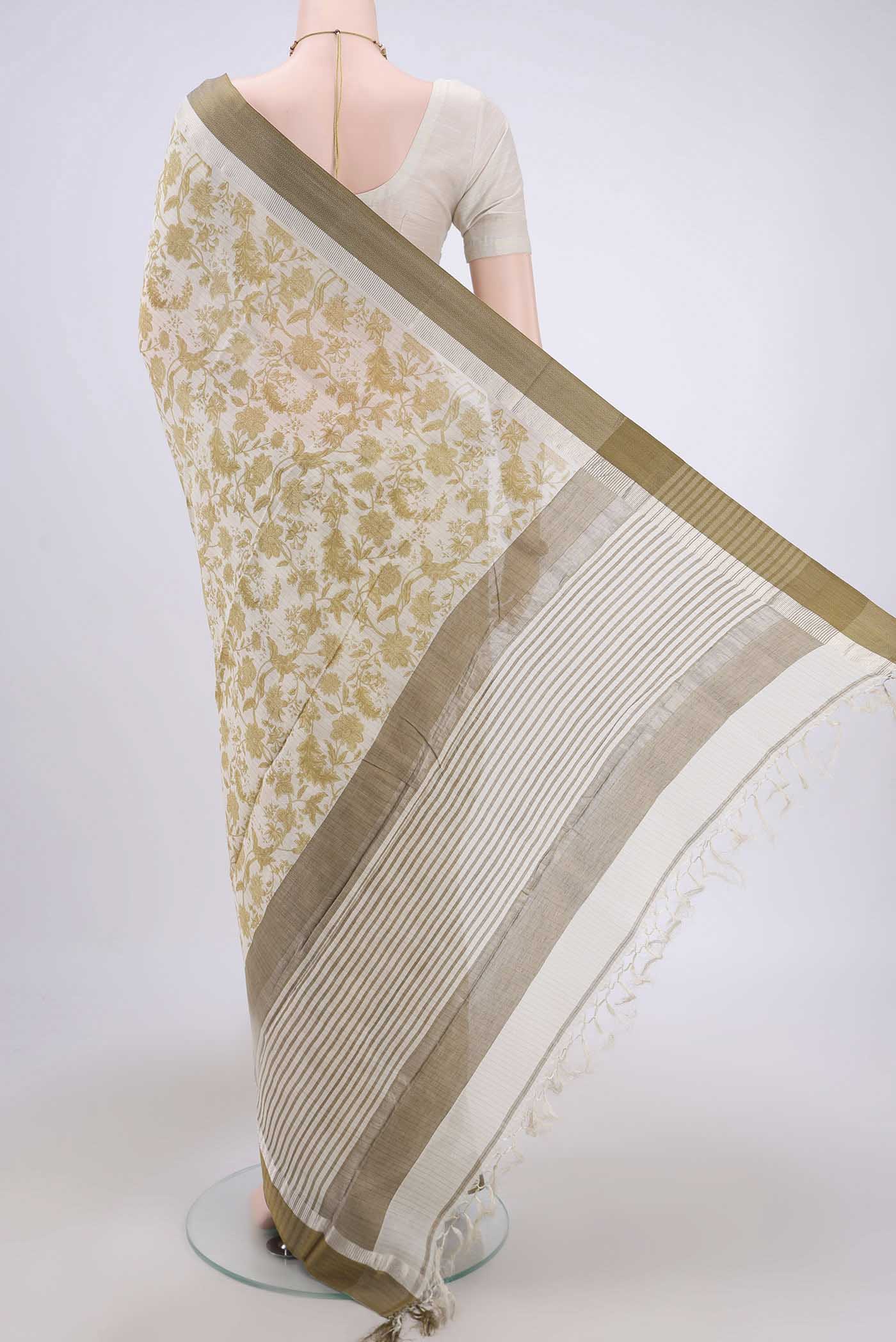 Flat view of Cream Tussar Saree with Floral Print on the body and Thread Border. 
