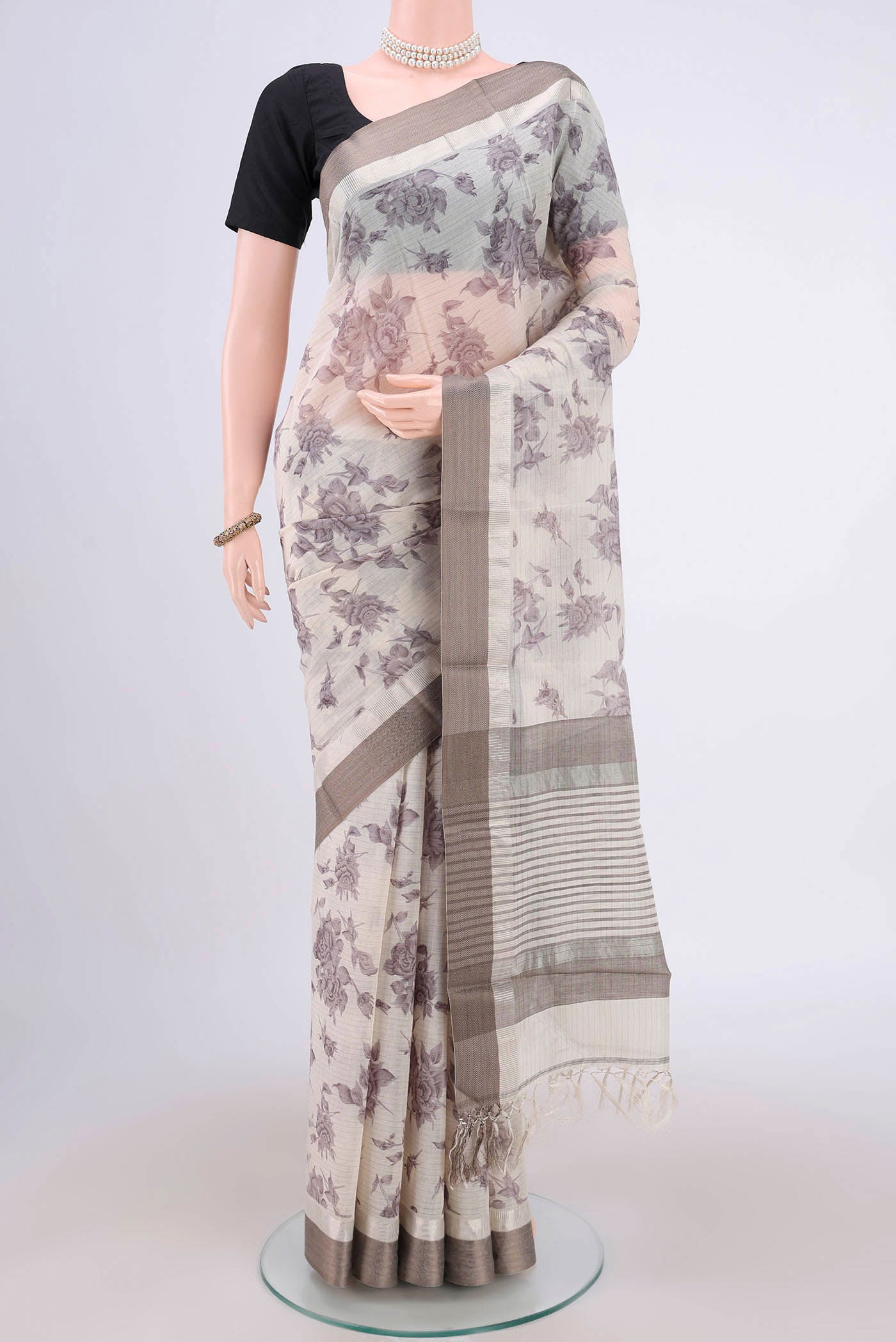 Beige Tussar Saree with Floral Print on the body and Thread Border.  displayed on a mannequin