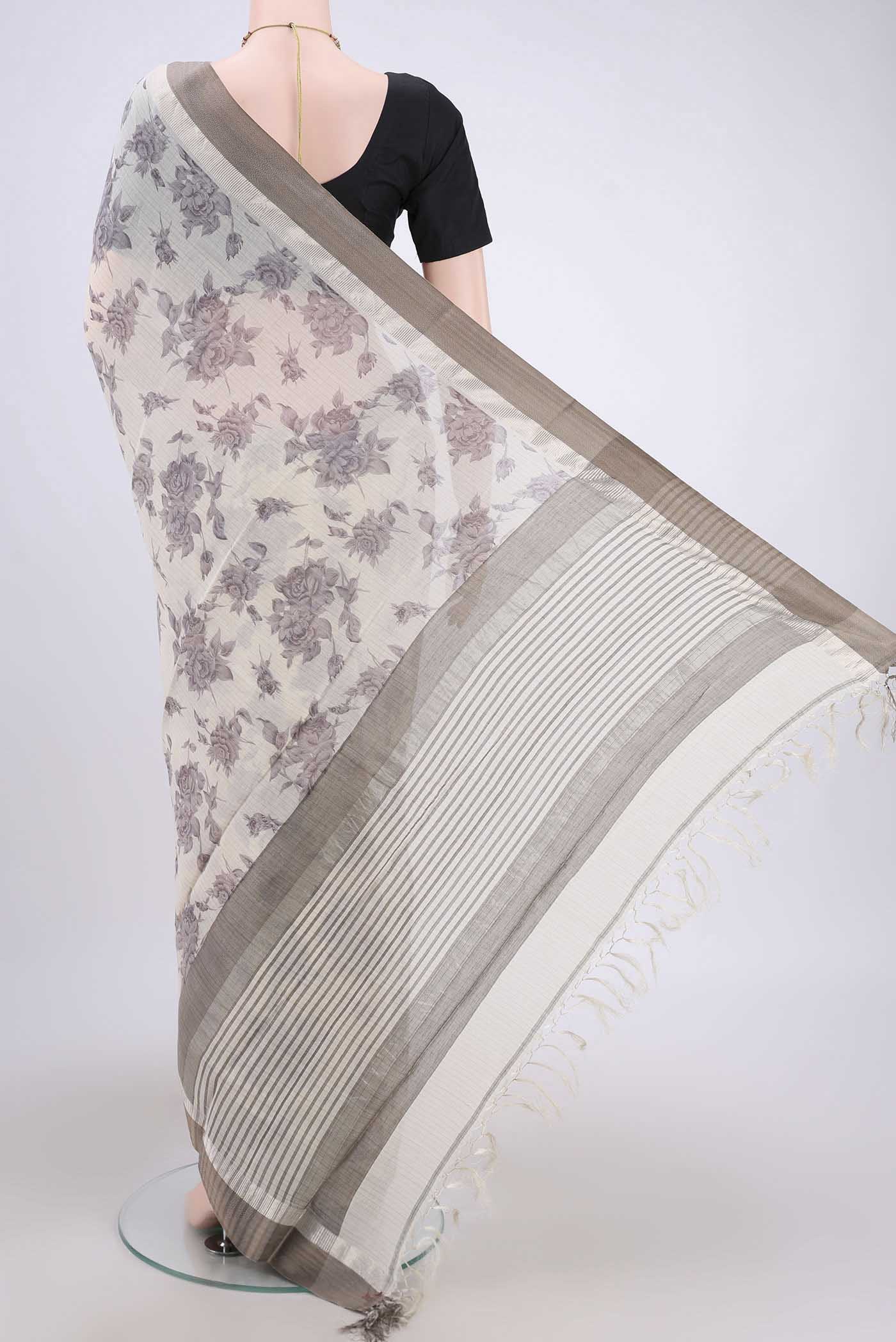 Flat view of Beige Tussar Saree with Floral Print on the body and Thread Border. 