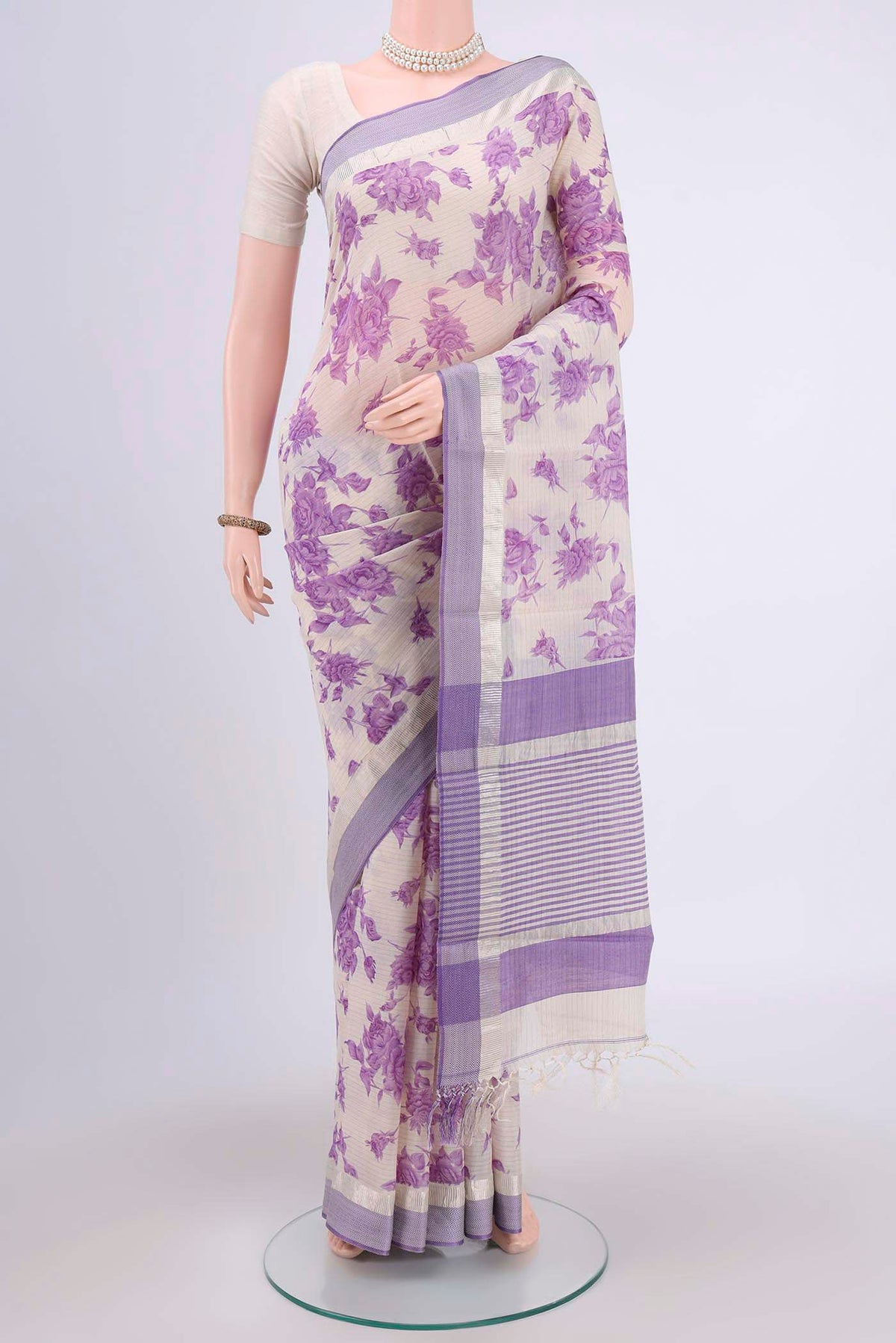 Off White Tussar Saree with Floral Print on the body and Plain Border.  displayed on a mannequin