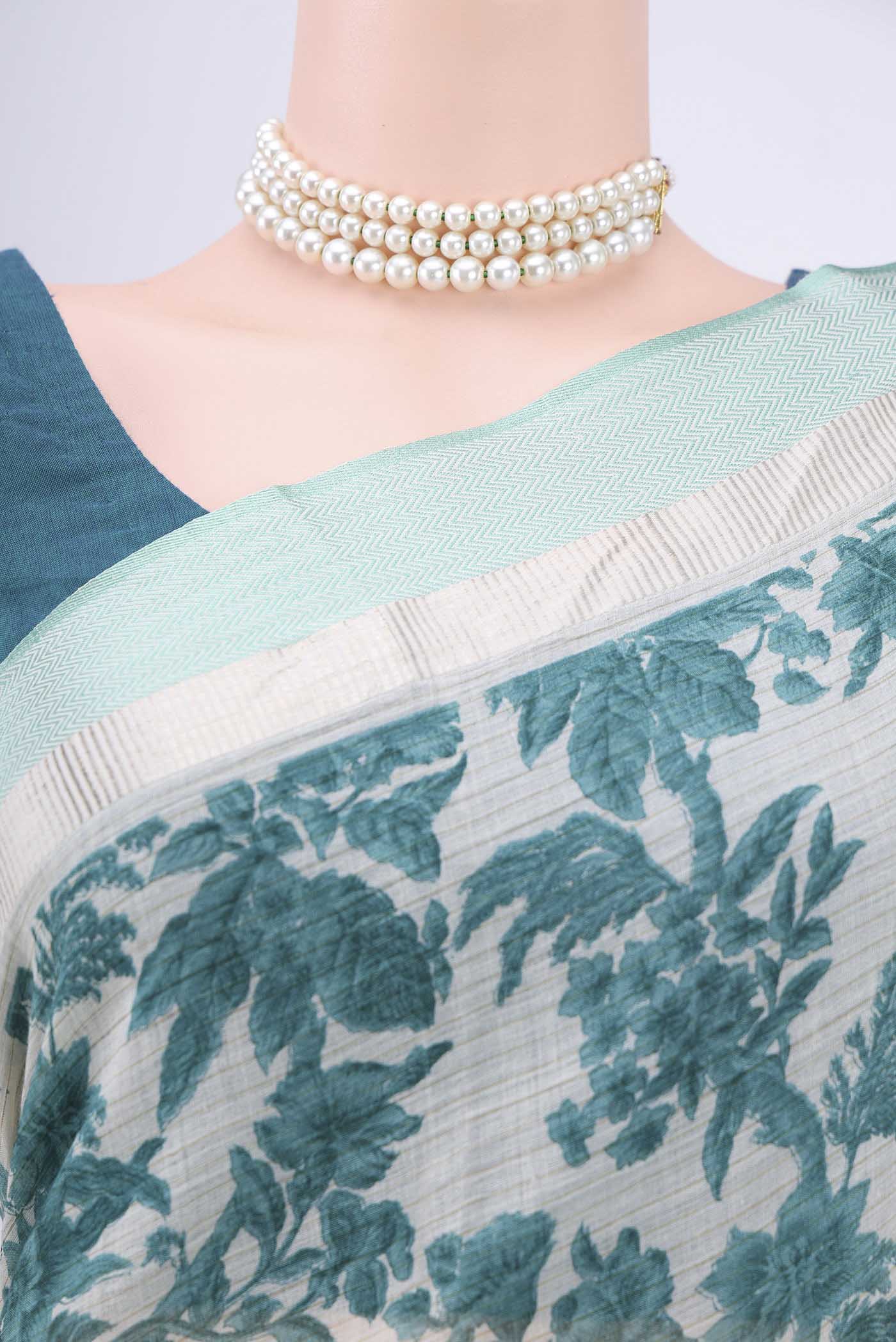 Border image of Beige Tussar Saree with Floral Print on the body and Thread Border. 
