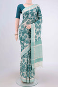Beige Tussar Saree with Floral Print on the body and Thread Border.  displayed on a mannequin