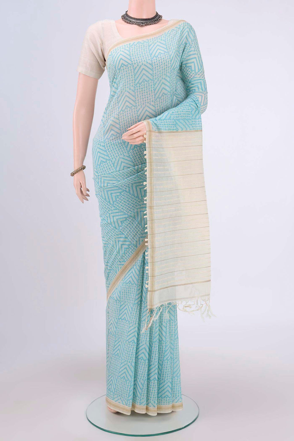 Blue Tussar Saree with Floral Print on the body and Plain Border.  displayed on a mannequin