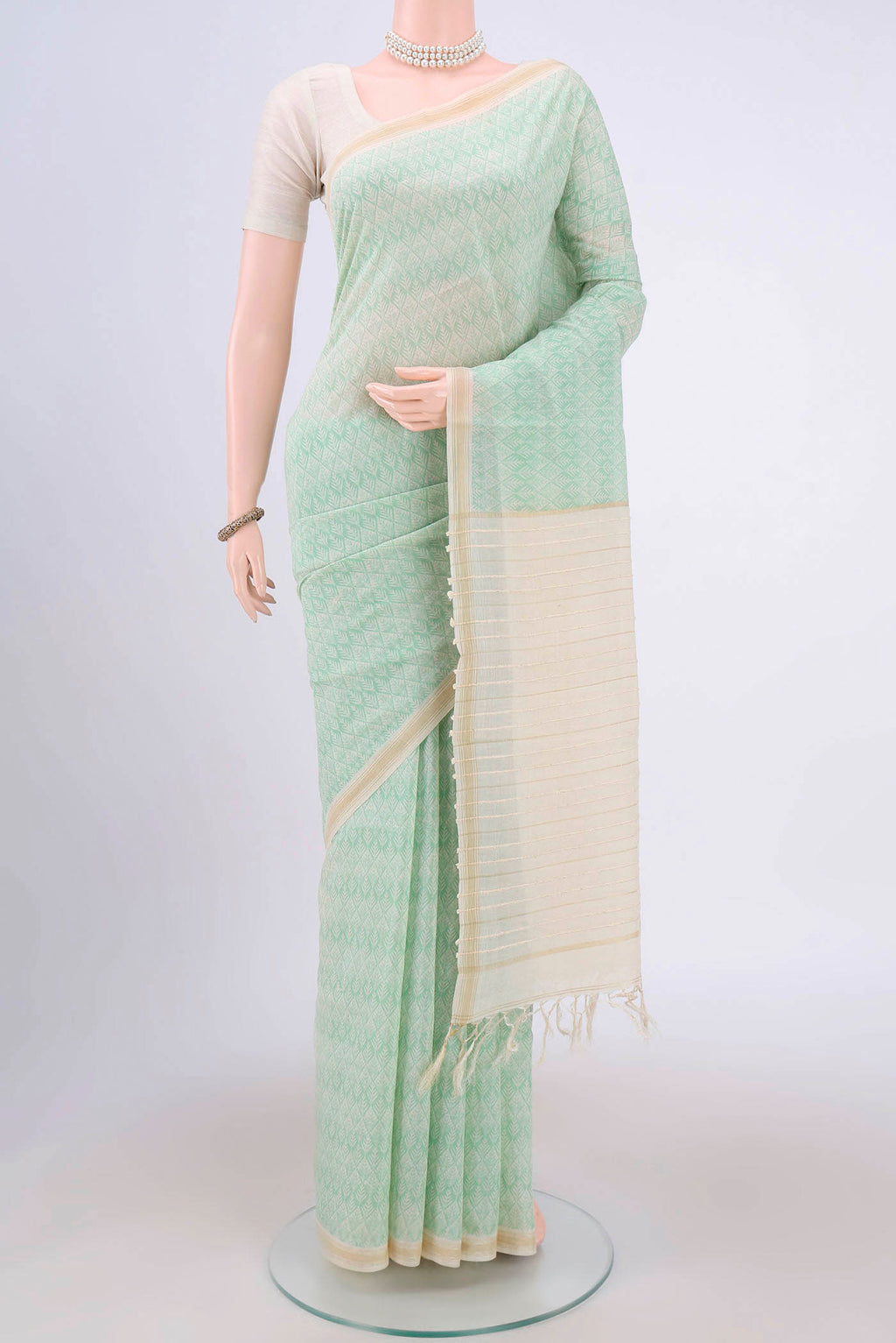 Sea Green Tussar Saree with Floral Print on the body and Plain Border.  displayed on a mannequin