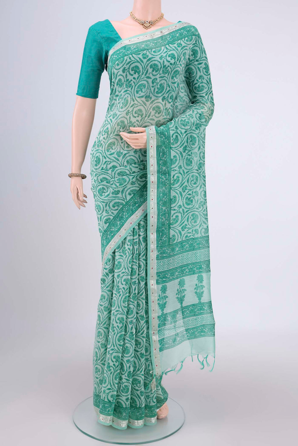 Sea Green Chanderi Silk Saree with Floral Print on the body and Zari Border.  displayed on a mannequin