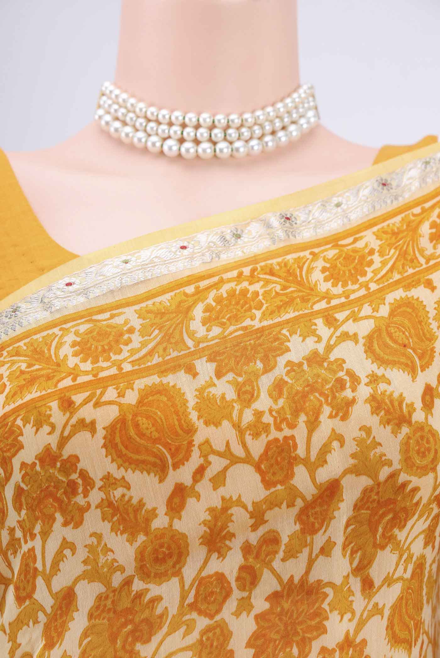 Border image of Yellow Tussar Saree with Floral Print on the body and Thread Border. 
