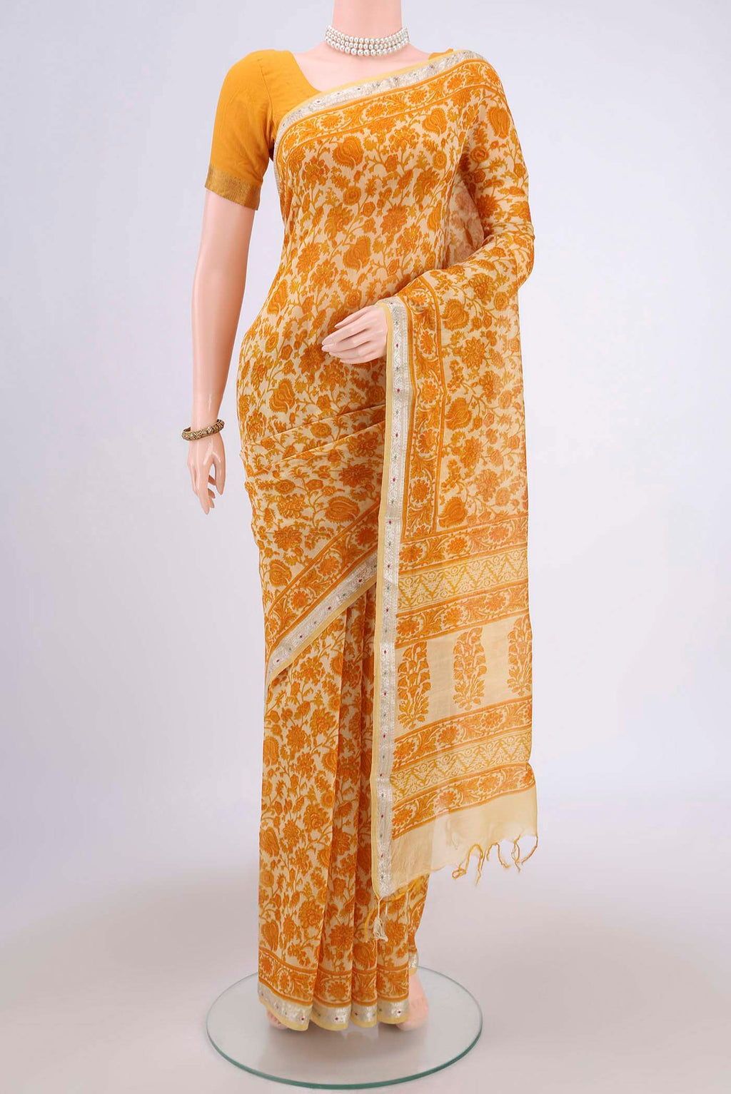 Yellow Tussar Saree with Floral Print on the body and Thread Border.  displayed on a mannequin