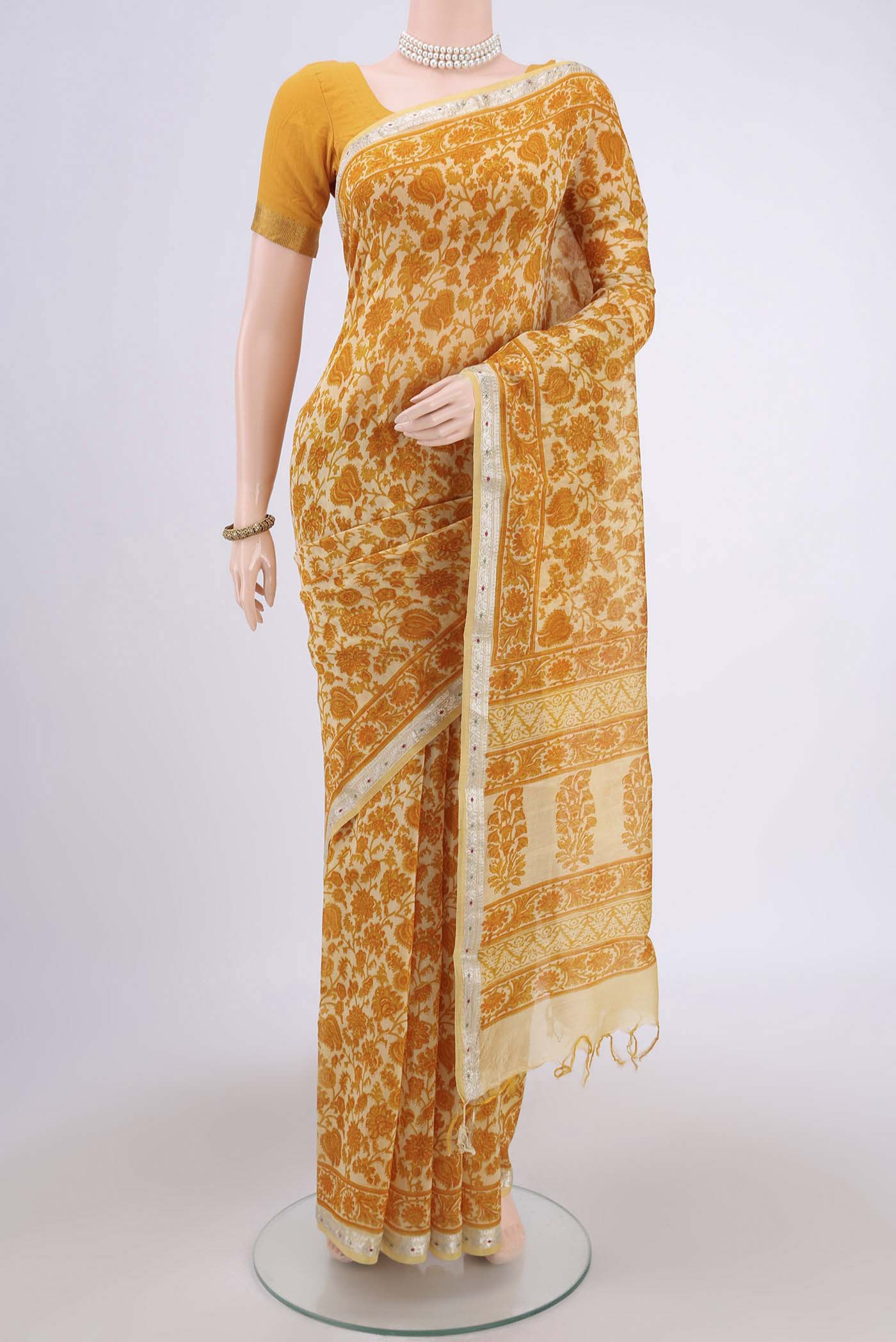 Yellow Tussar Saree with Floral Print on the body and Thread Border.  displayed on a mannequin