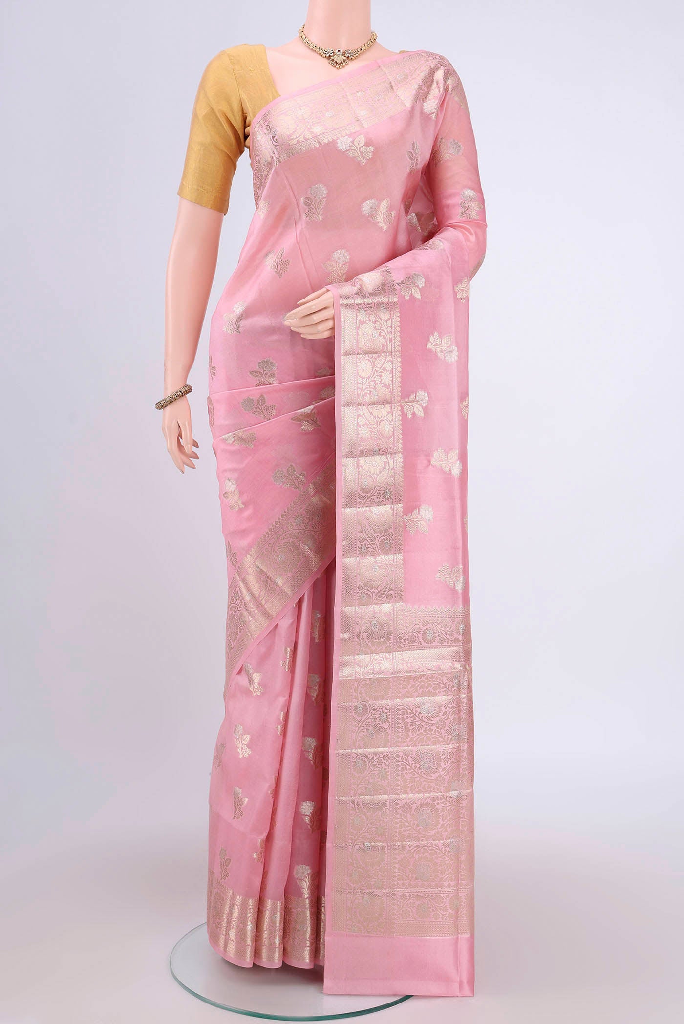Rose pink Banarasi Raw Silk Saree with Zari Butta on the body and Zari Border.  displayed on a mannequin