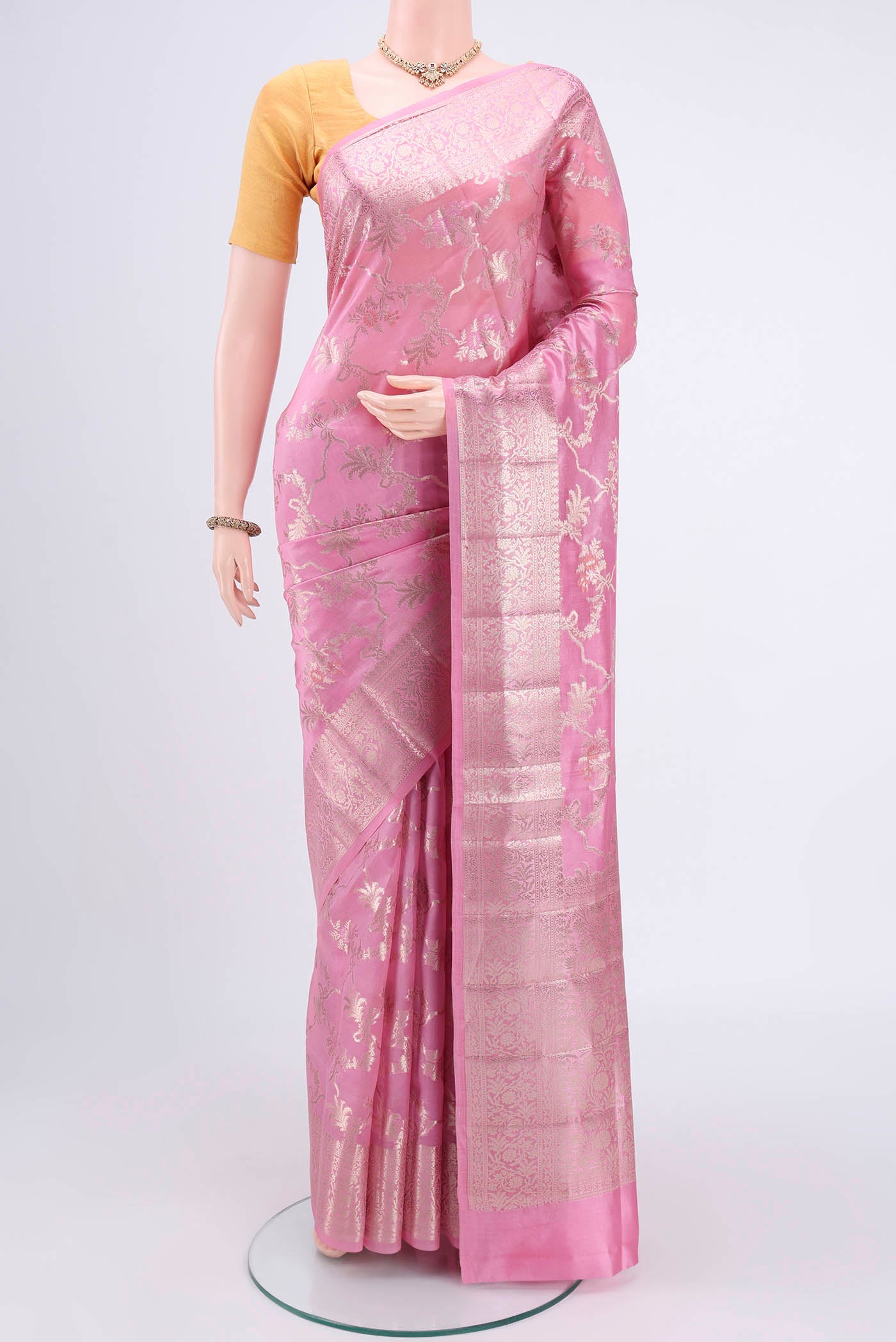 Rose pink Banarasi Raw Silk Saree with Zari Butta on the body and Zari Border.  displayed on a mannequin