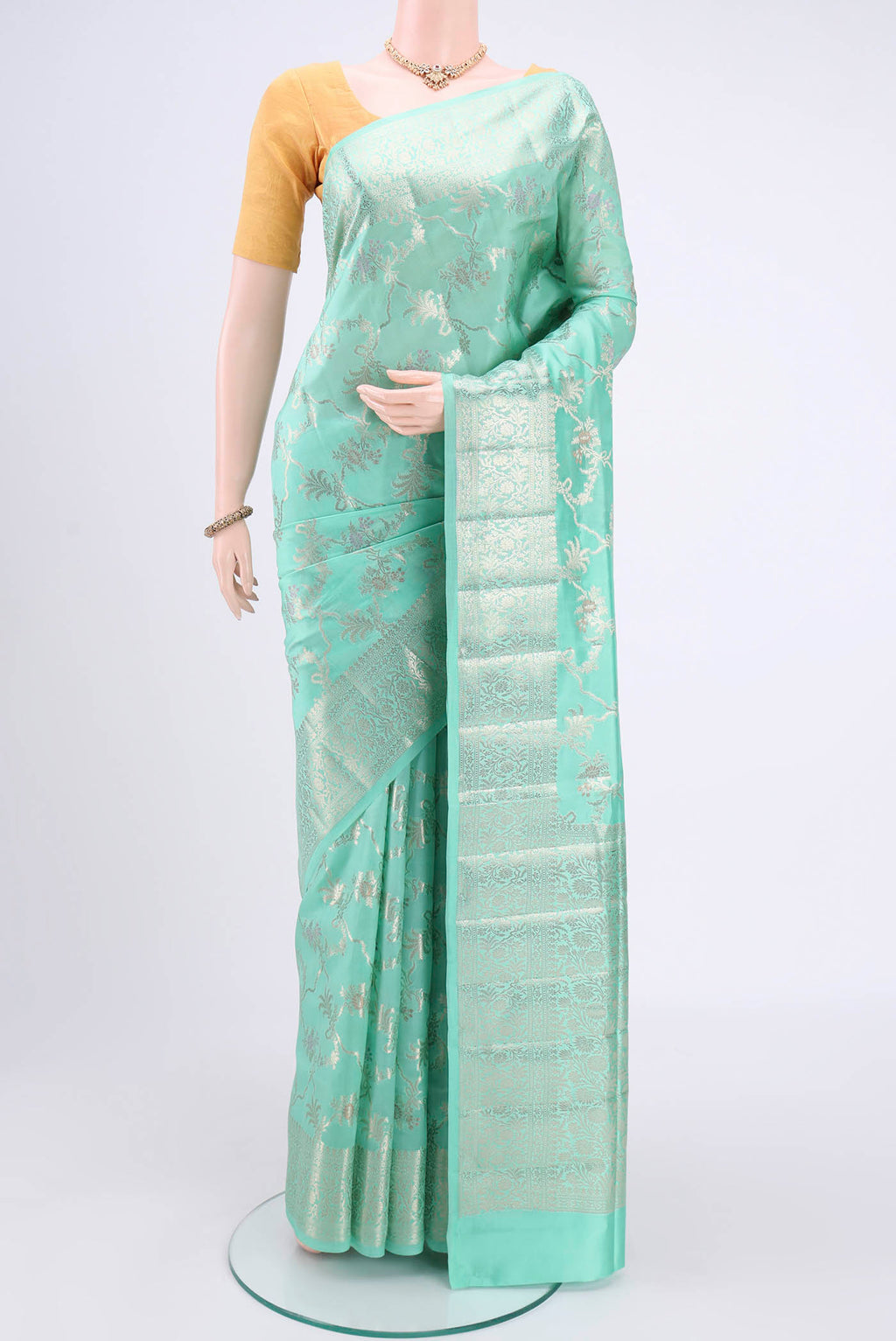 Mint Green Banarasi Raw Silk Saree with Zari Butta on the body and Zari Border.  displayed on a mannequin