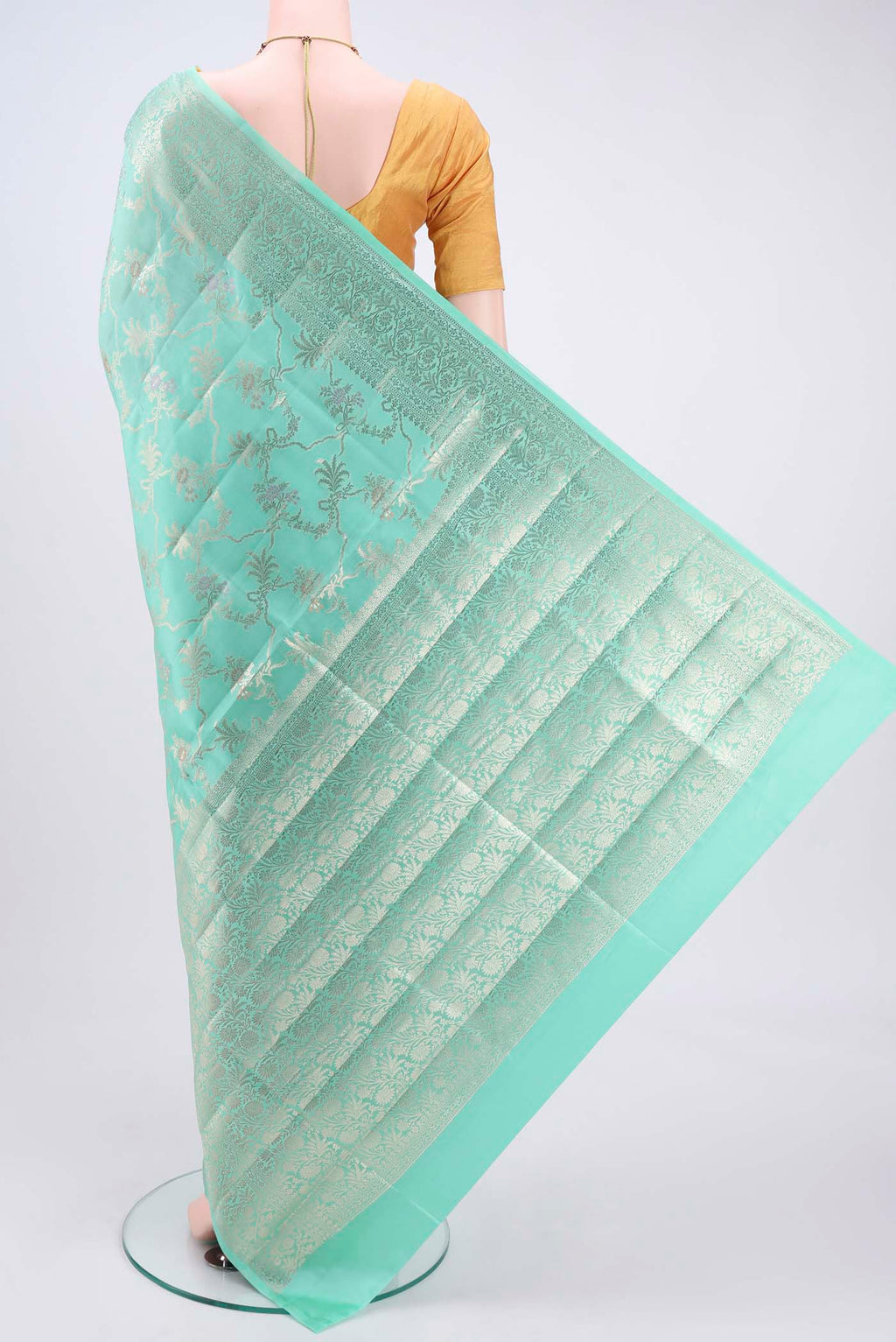 Flat view of Mint Green Banarasi Raw Silk Saree with Zari Butta on the body and Zari Border. 