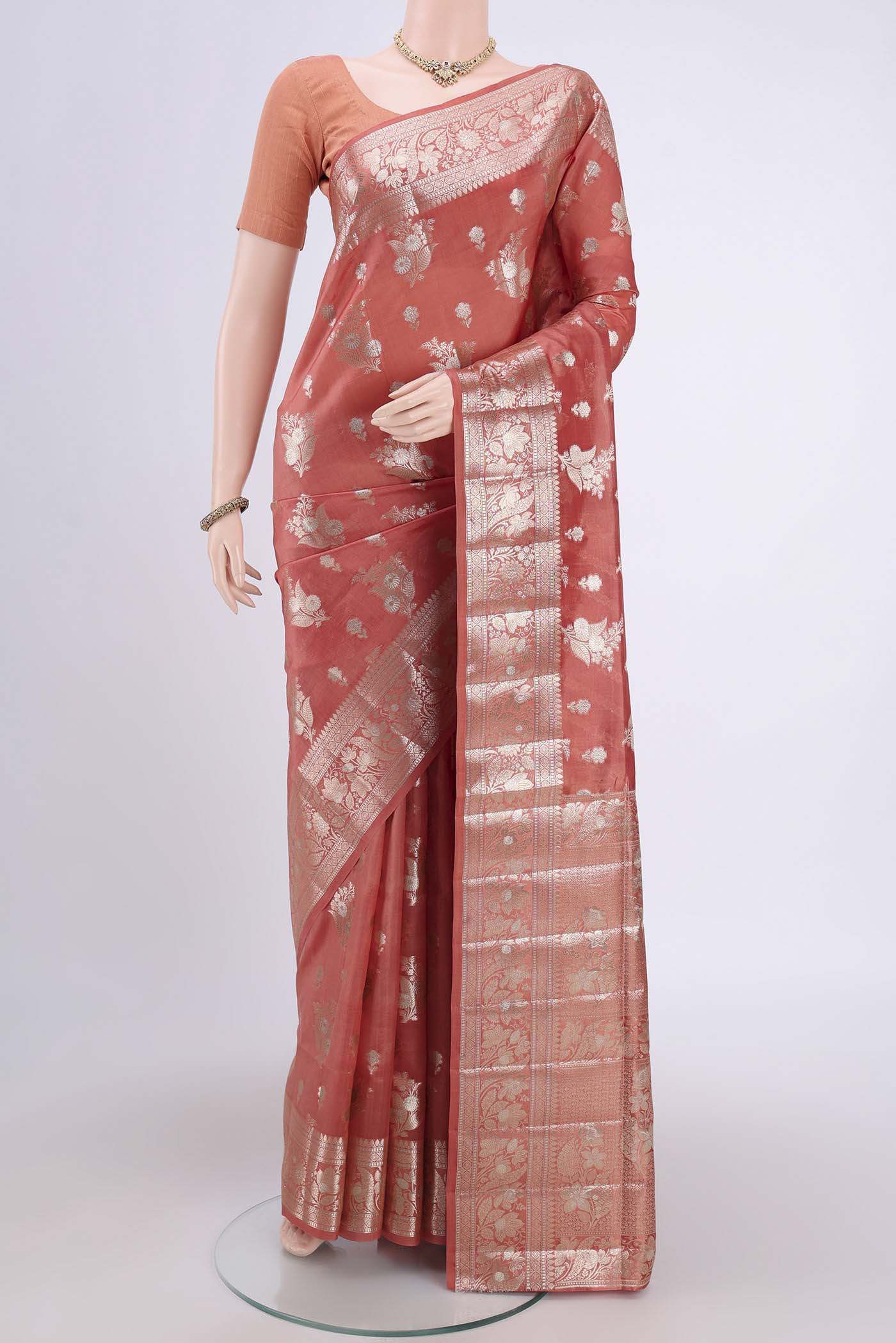 Peach Banarasi Raw Silk Saree with Zari Butta on the body and Zari Border.  displayed on a mannequin