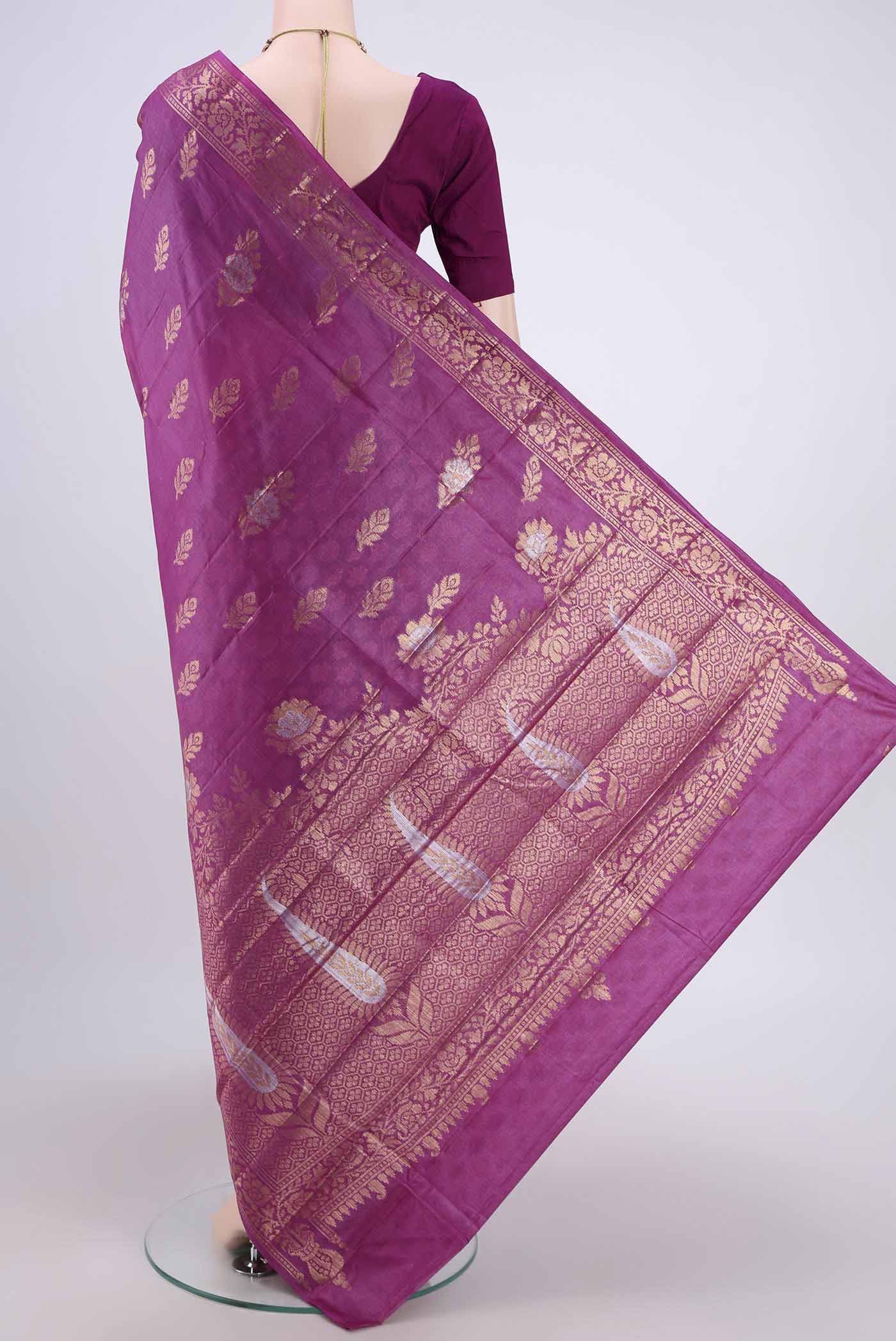 Flat view of Purple Banarasi Tussar Silk Saree with Zari Butta on the body and Zari Border. 