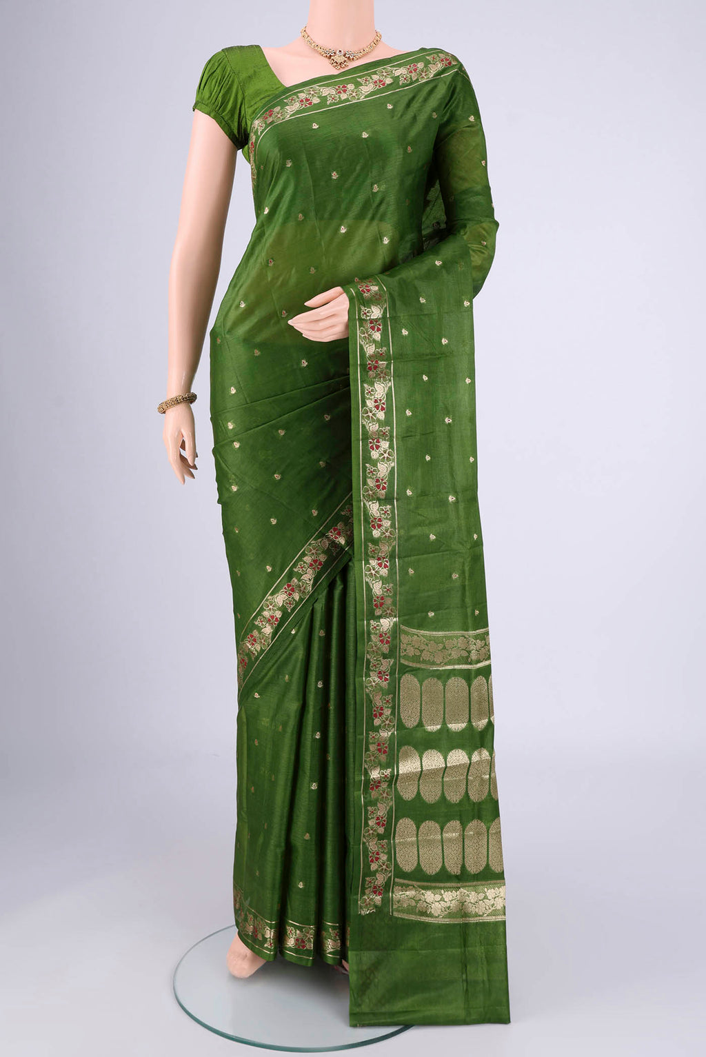 Green Banarasi Tussar Silk Saree with Zari And Thread Butta on the body and Zari And Thread Border.  displayed on a mannequin