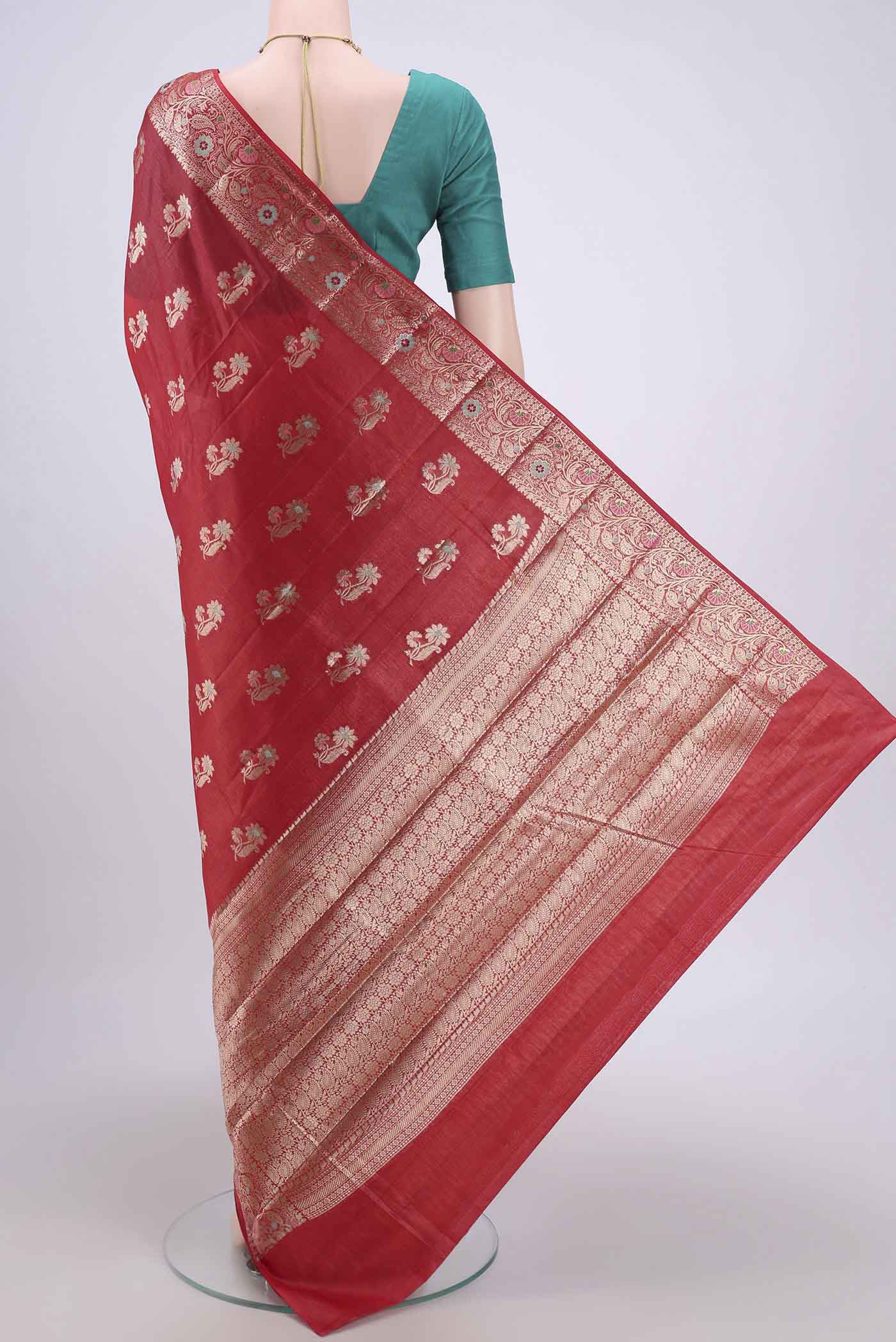 Flat view of Red Banarasi Tussar Silk Saree with Zari And Thread Butta on the body and Zari And Thread Border. 