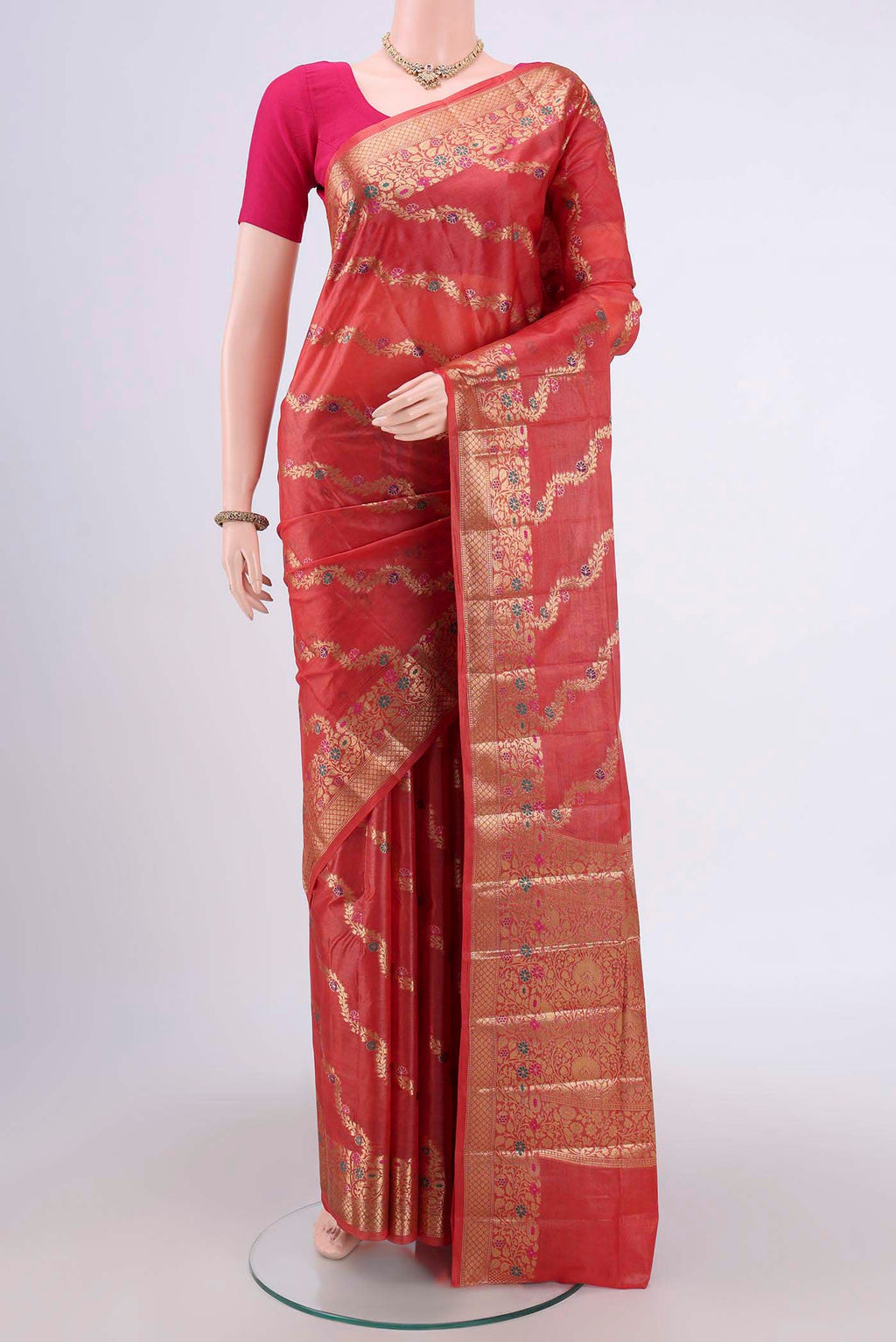 Rust Banarasi Tussar Silk Saree with Zari Brocade on the body and Zari And Thread Border.  displayed on a mannequin
