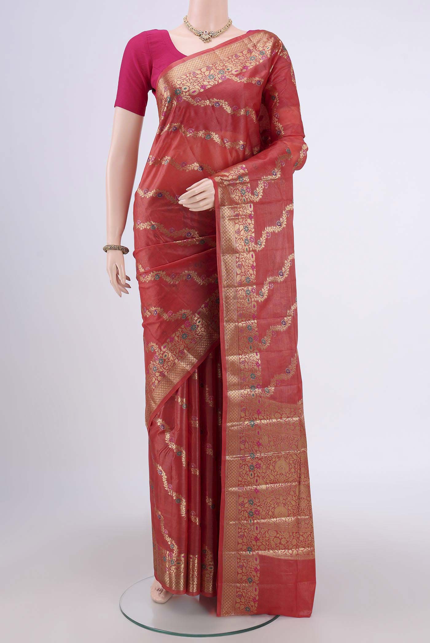 Rust Banarasi Tussar Silk Saree with Zari Brocade on the body and Zari And Thread Border.  displayed on a mannequin