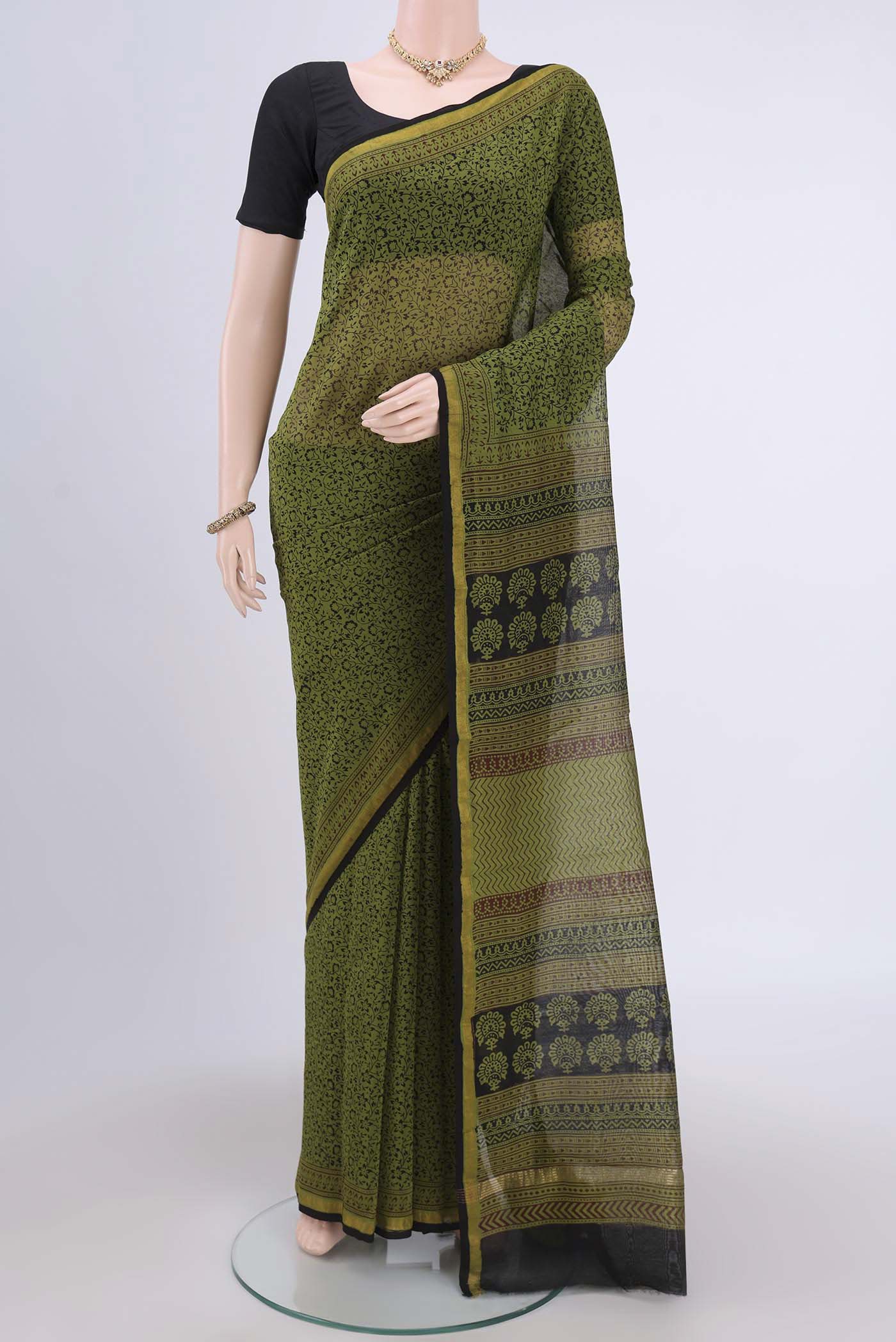Mehandi Green Maheshwari Silk Cotton Saree with Printed design on the body and Zari Border.  displayed on a mannequin