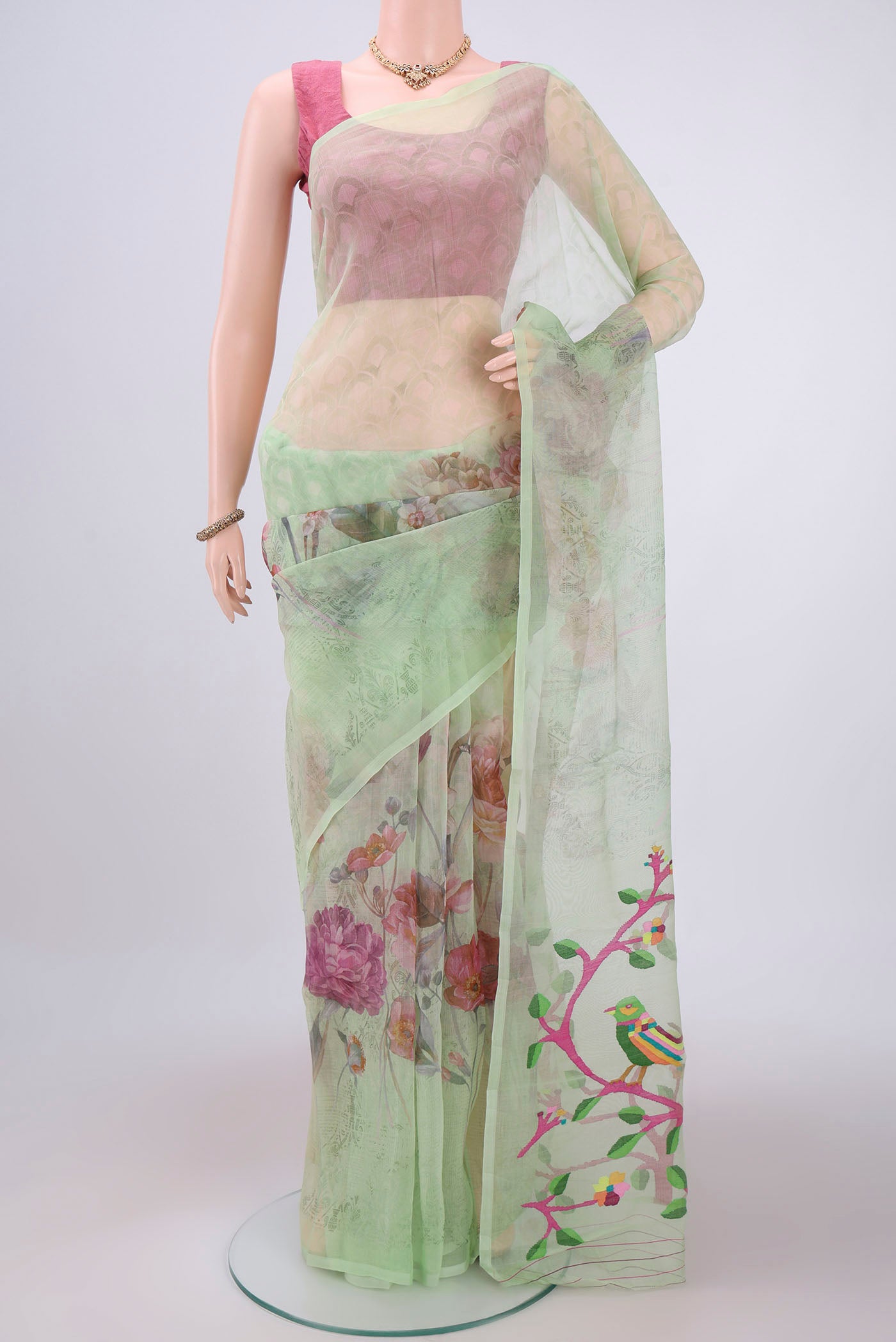 Mint Green Organza Silk Saree with Printed design on the body and Plain Border.  displayed on a mannequin