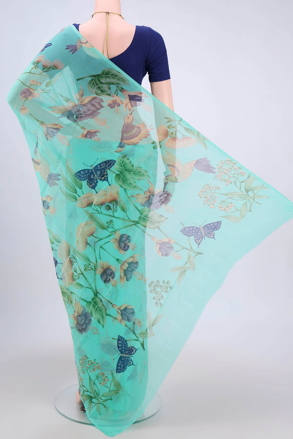 Flat view of Turquoise Mysore Crepe Saree with Floral Print on the body and Zari Border. 