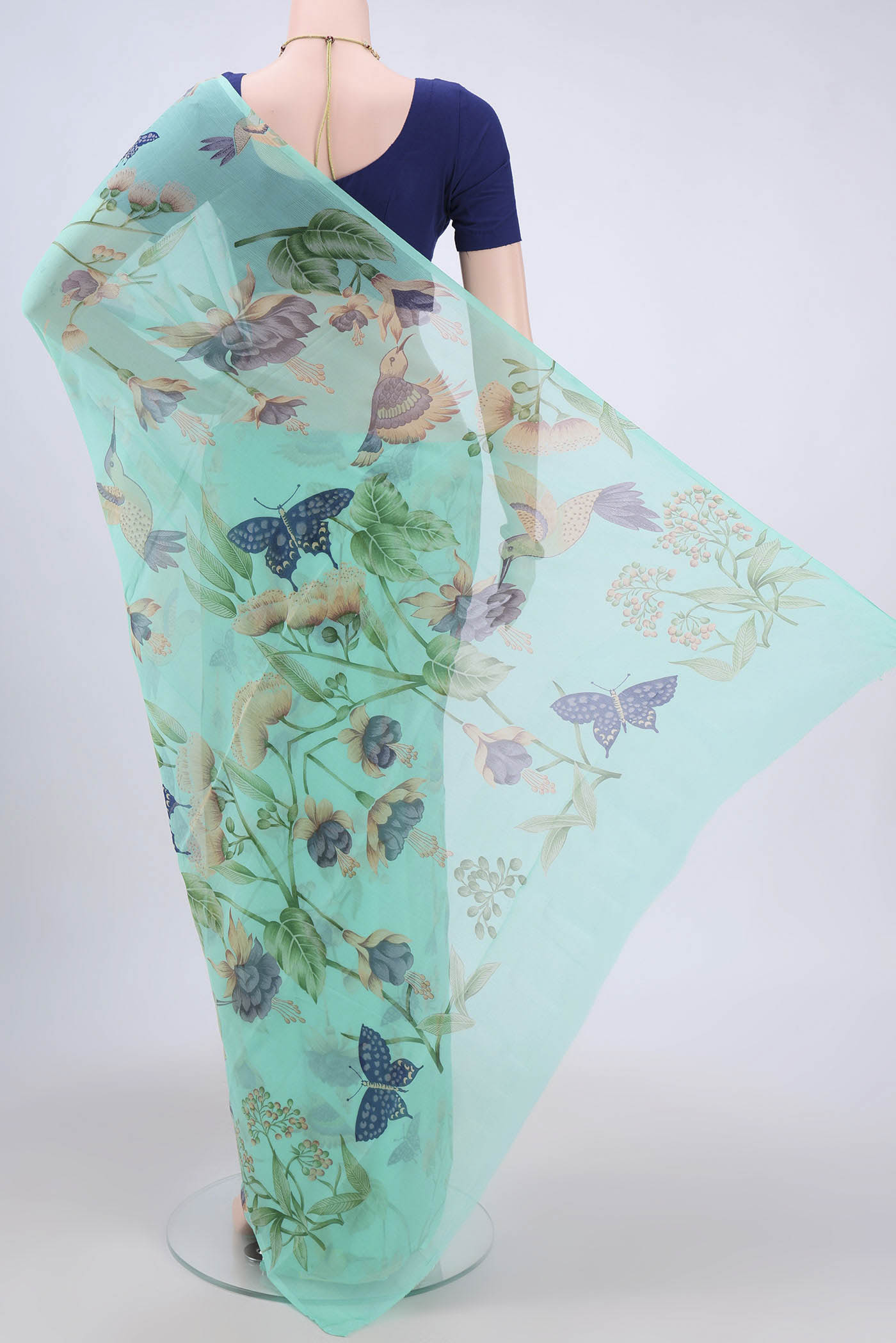 Flat view of Turquoise Mysore Crepe Saree with Floral Print on the body and Zari Border. 