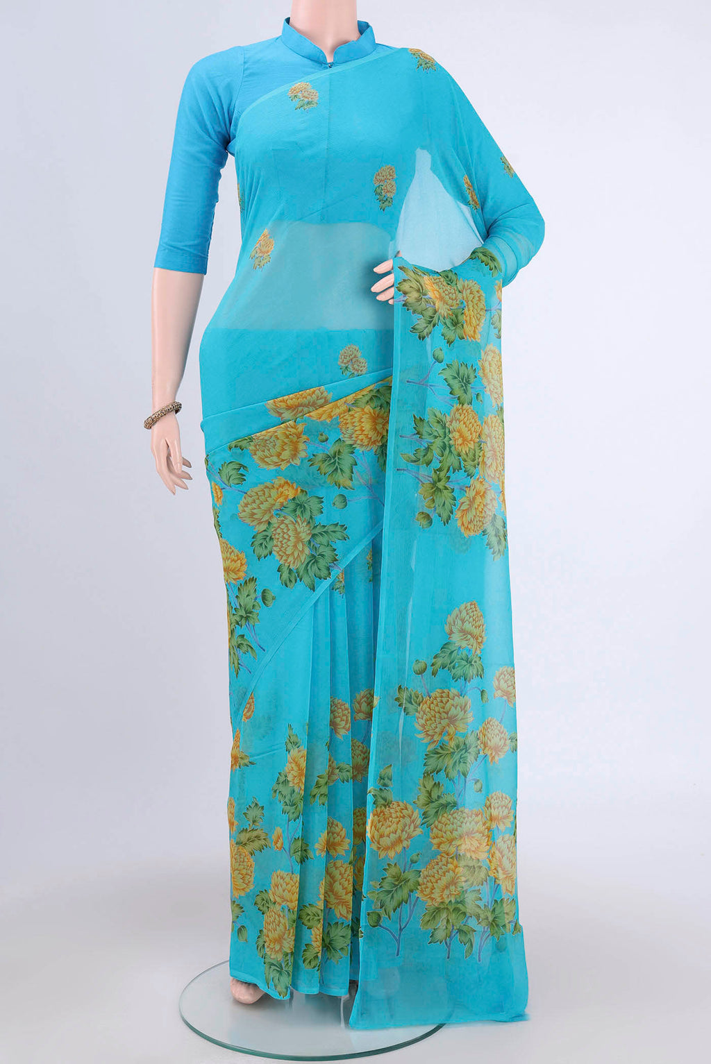 Electric Blue Mysore Crepe Saree with Floral Print on the body and Zari Border.  displayed on a mannequin