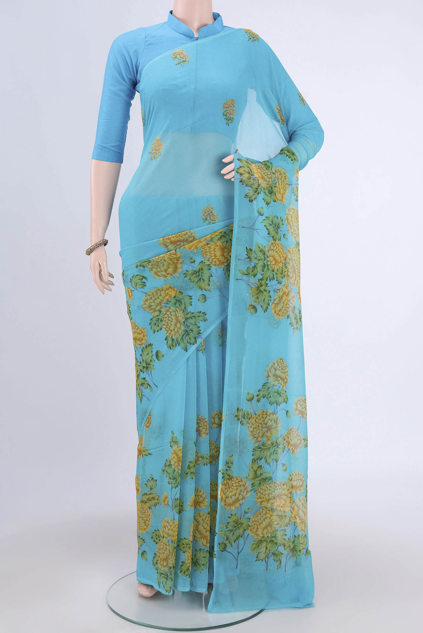 Electric Blue Mysore Crepe Saree with Floral Print on the body and Zari Border.  displayed on a mannequin