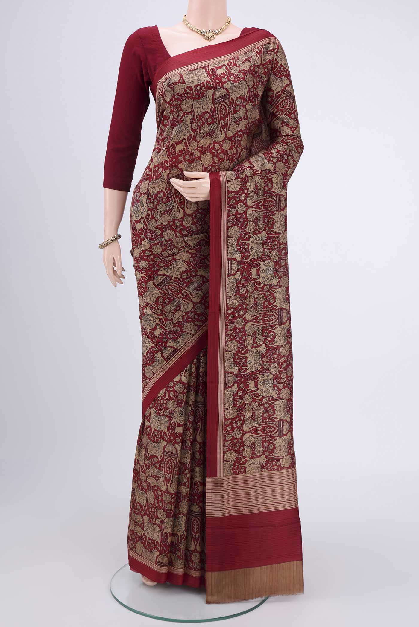 Maroon Printed Silk Saree with Printed design on the body and Plain Border.  displayed on a mannequin
