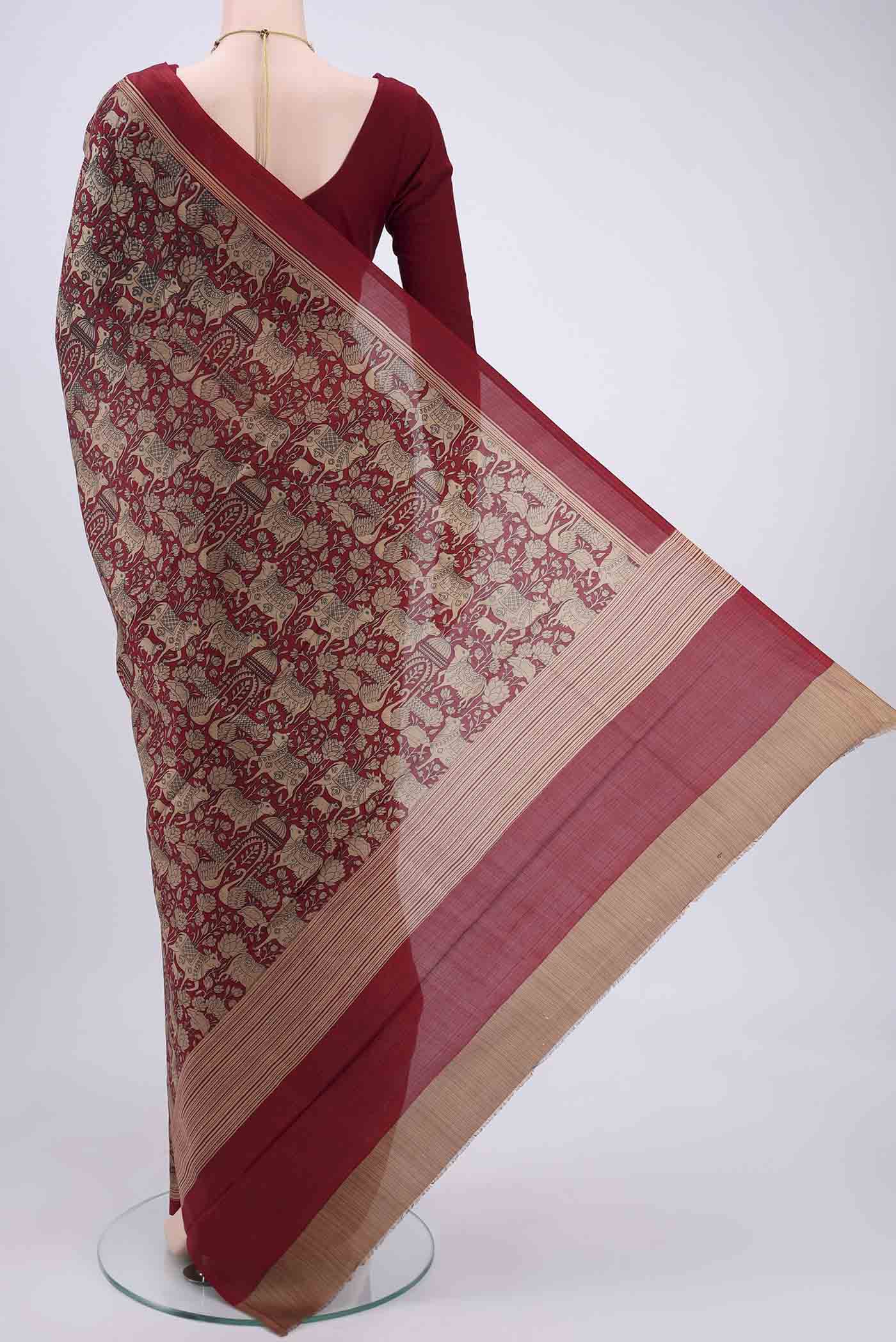 Flat view of Maroon Printed Silk Saree with Printed design on the body and Plain Border. 