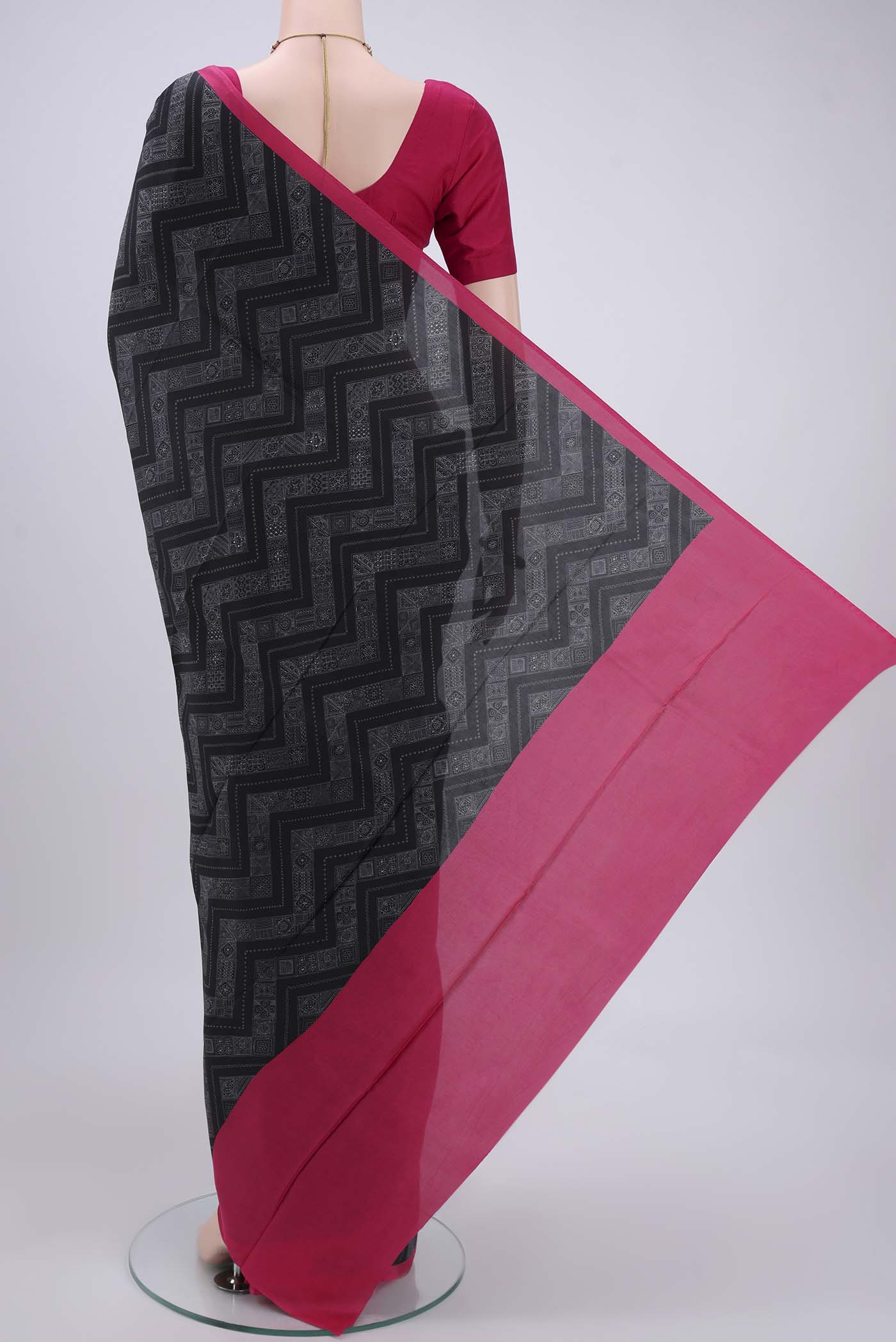 Flat view of Black Printed Silk Saree with Printed design on the body and Plain Border. 