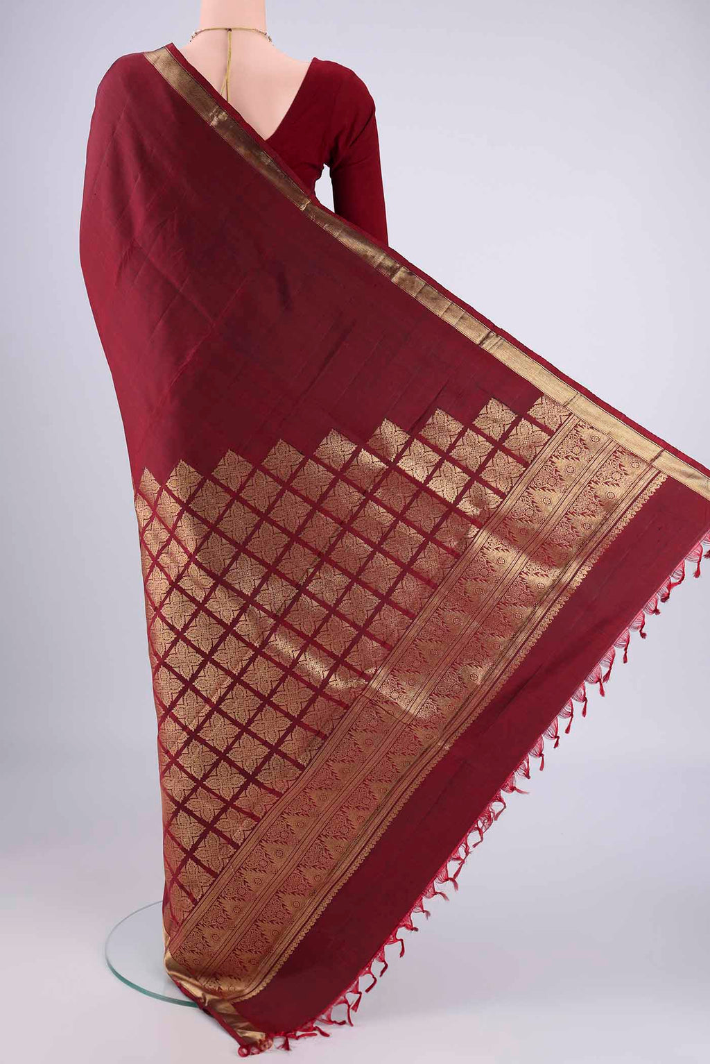 Flat view of Pure Silk Pure Zari Maroon Kanjivaram Saree with Plain Body and Zari Border. 