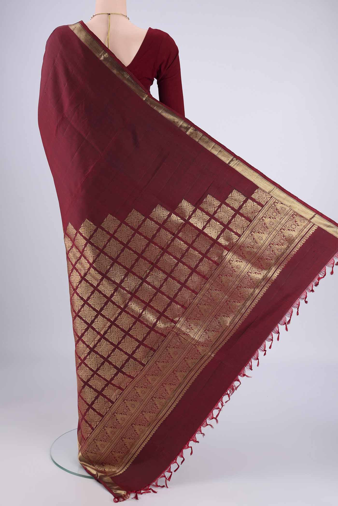 Flat view of Pure Silk Pure Zari Maroon Kanjivaram Saree with Plain Body and Zari Border. 
