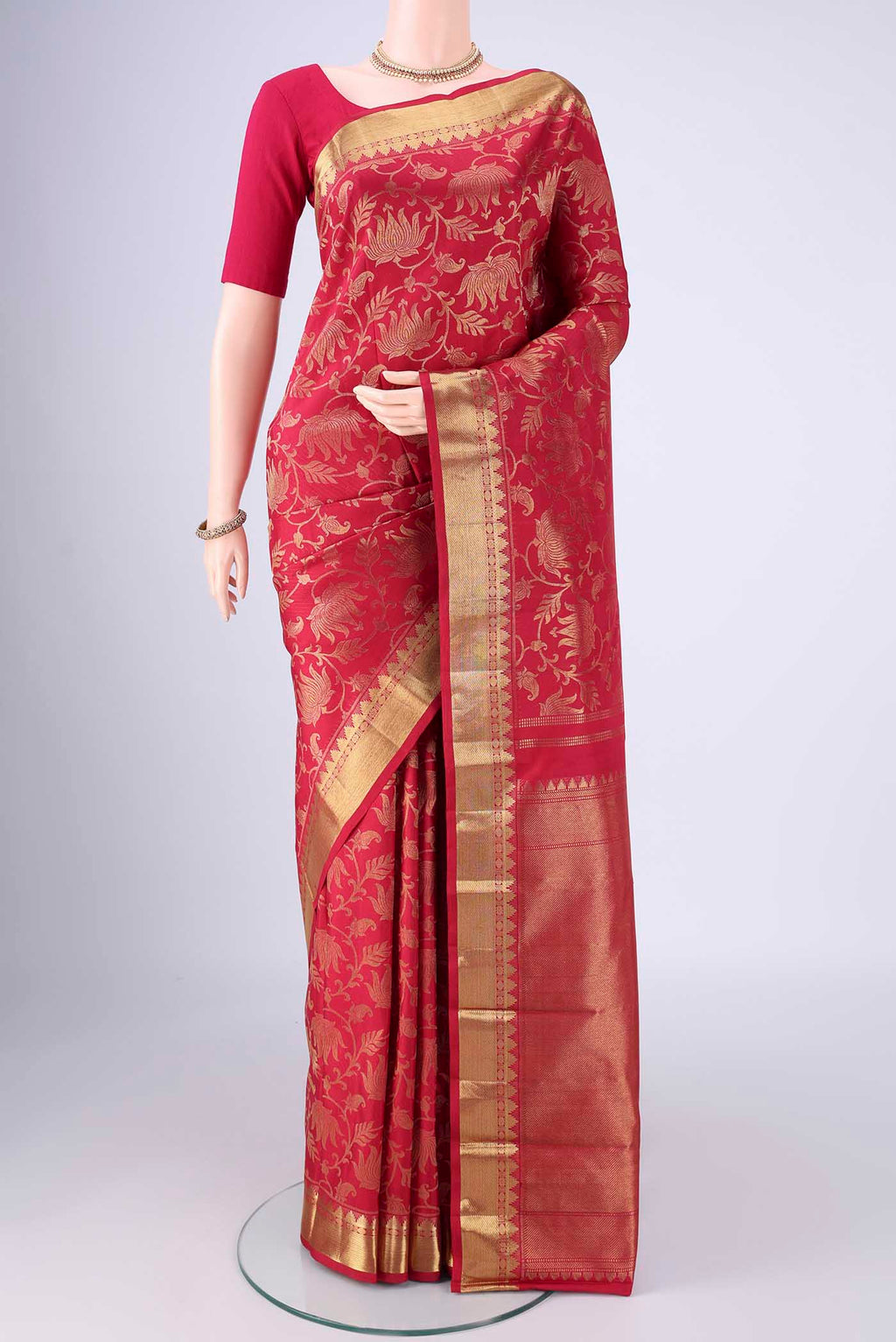 Maroon Kanjivaram Silk Saree with Zari Brocade on the body and Zari Border.  displayed on a mannequin