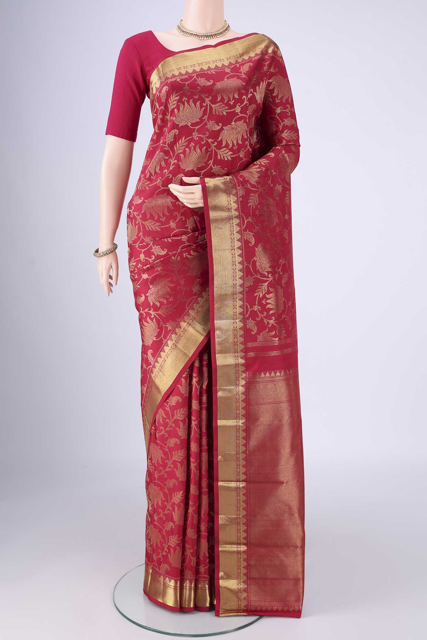 Maroon Kanjivaram Silk Saree with Zari Brocade on the body and Zari Border.  displayed on a mannequin